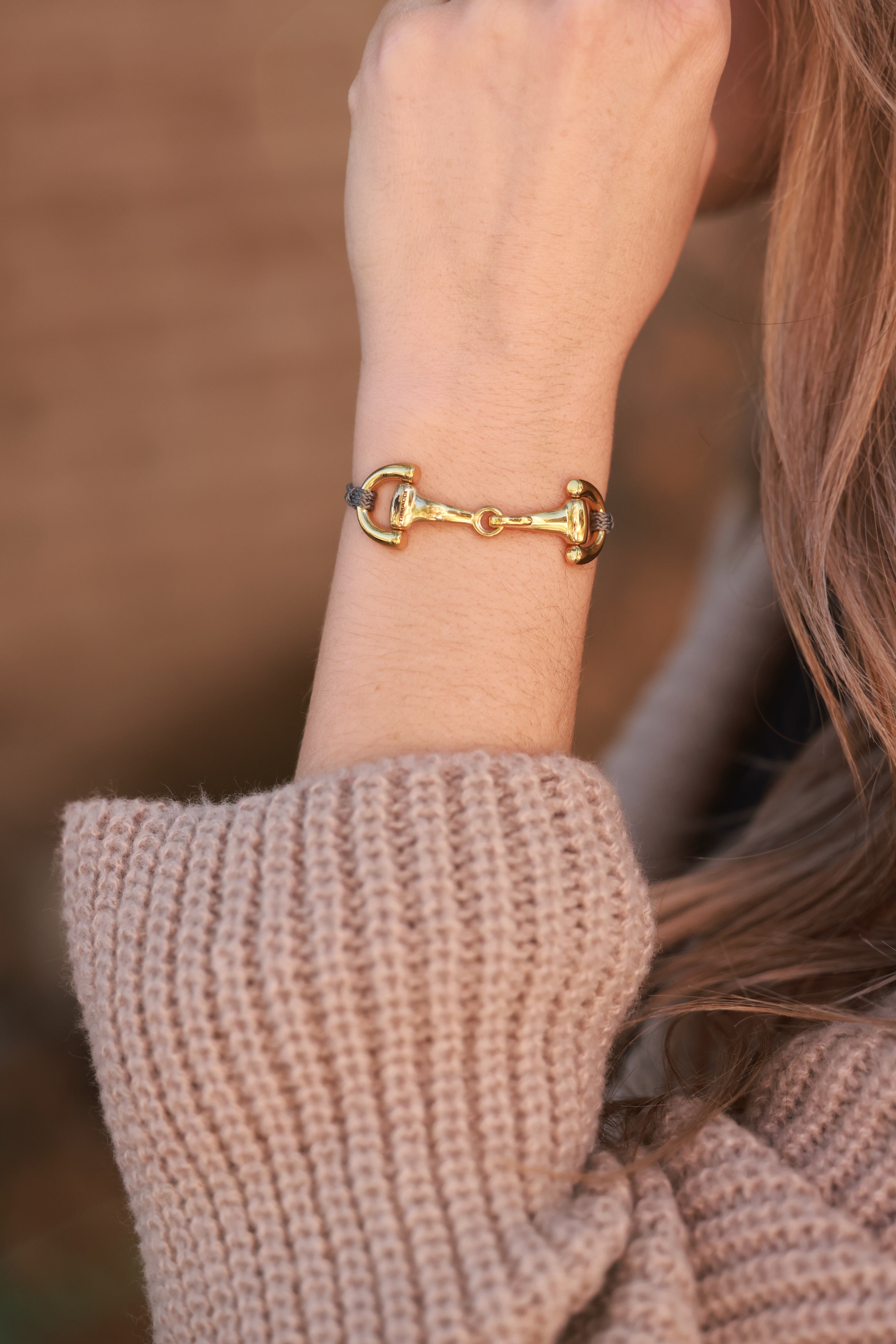 Grey Pony Bracelet from Stylish Equestrian x Dimacci, handmade in Germany with an adjustable nylon band and polished stainless steel snaffle bit detail. Elegant, dainty equestrian bracelet perfect for layering or gifting to horse lovers.