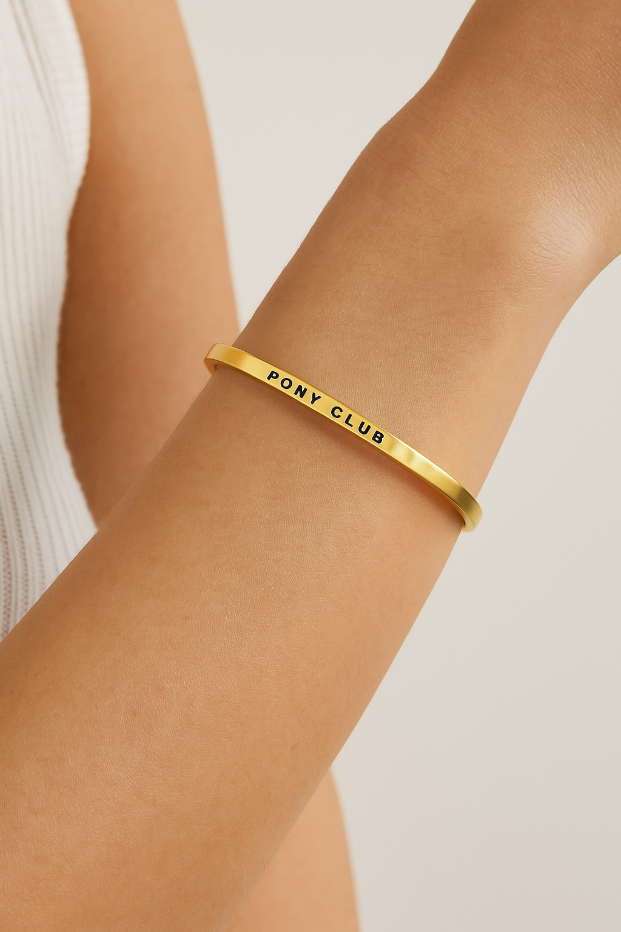 Gold-dipped stainless steel bangle engraved with an equestrian-inspired affirmation. Elegant and adjustable design for horse lovers, featuring a sleek, minimalist finish. Shown as part of the Pony Club collection, symbolizing strength, joy, and love for riding.