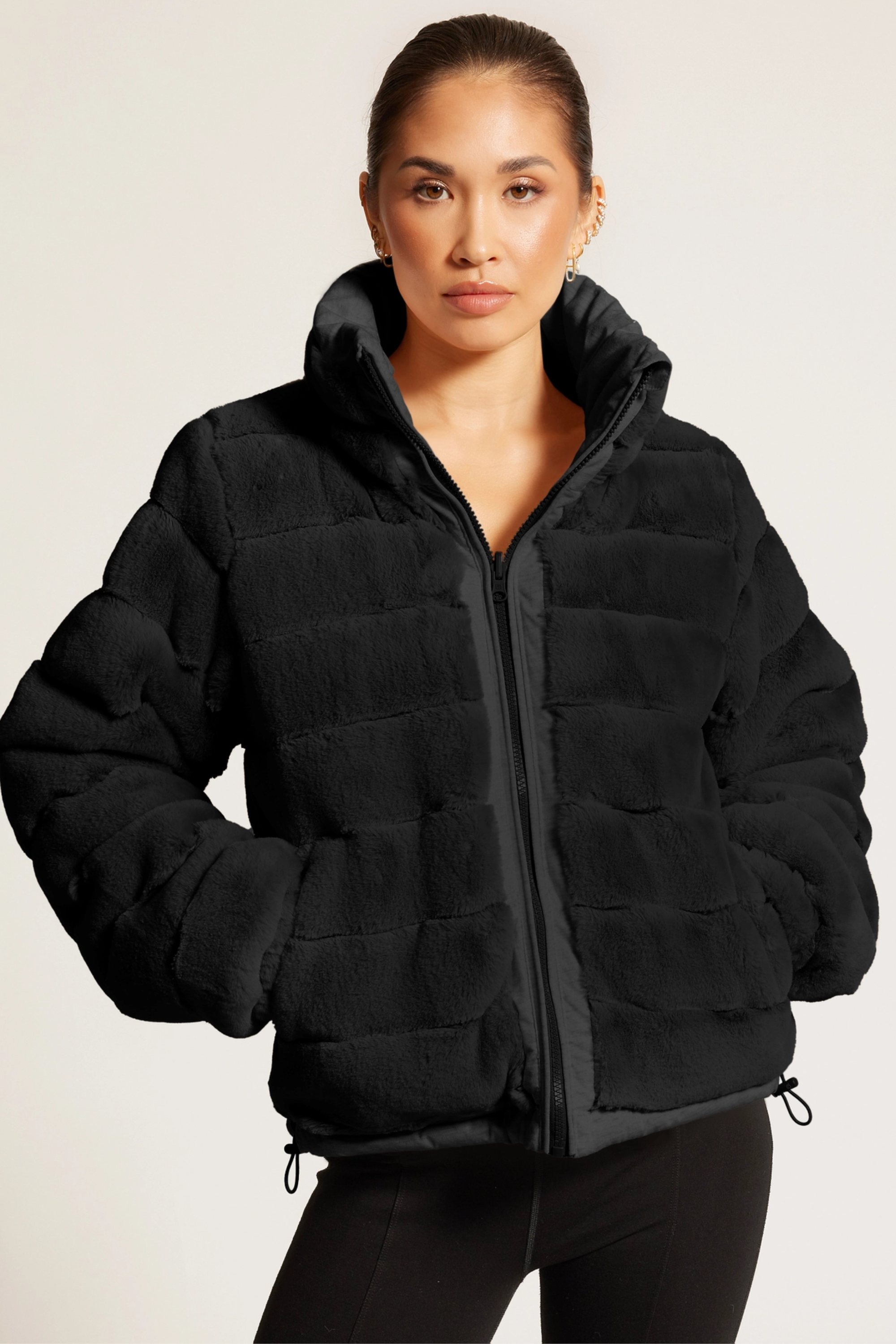 Reversible puffer jacket, Faux fur lined coat, Winter adventure jacket, Black insulated puffer, Stylish outdoor layer Black Reversible Puffer Jacket featuring a sleek exterior and ultra-soft faux fur interior for versatile styling. Down-filled for warmth with adjustable drawstring waist, hidden hood, and thumbholes for comfort. A stylish, adventure-ready equestrian-inspired winter coat perfect from trails to town.