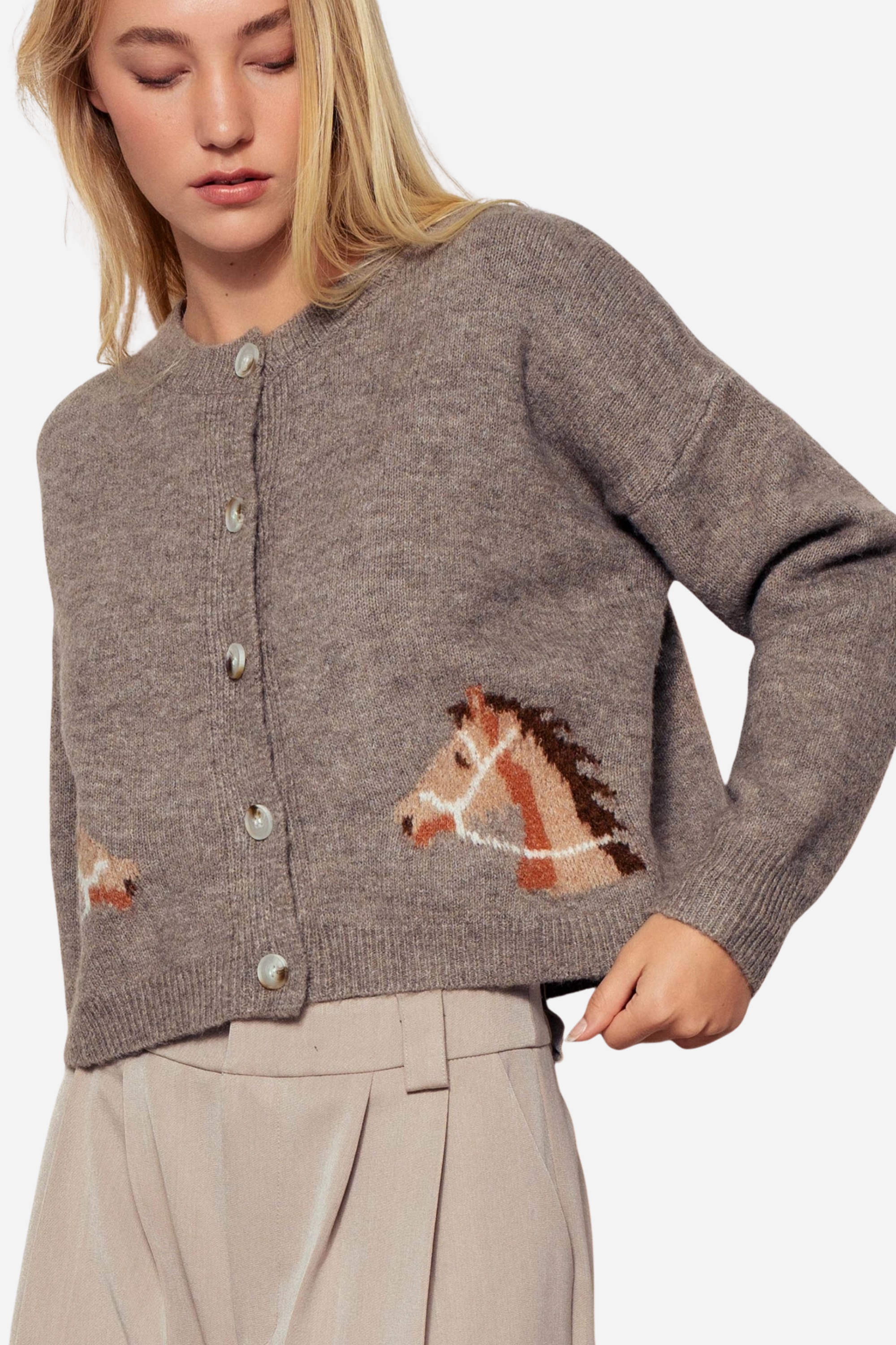 Gray knit cardigan with a crew neckline, button-front closure, and ribbed trim. Features playful horse head designs on each lower front panel, creating a rustic, equestrian-inspired look. Made from a soft acrylic-polyester-spandex blend in a relaxed, cropped fit.