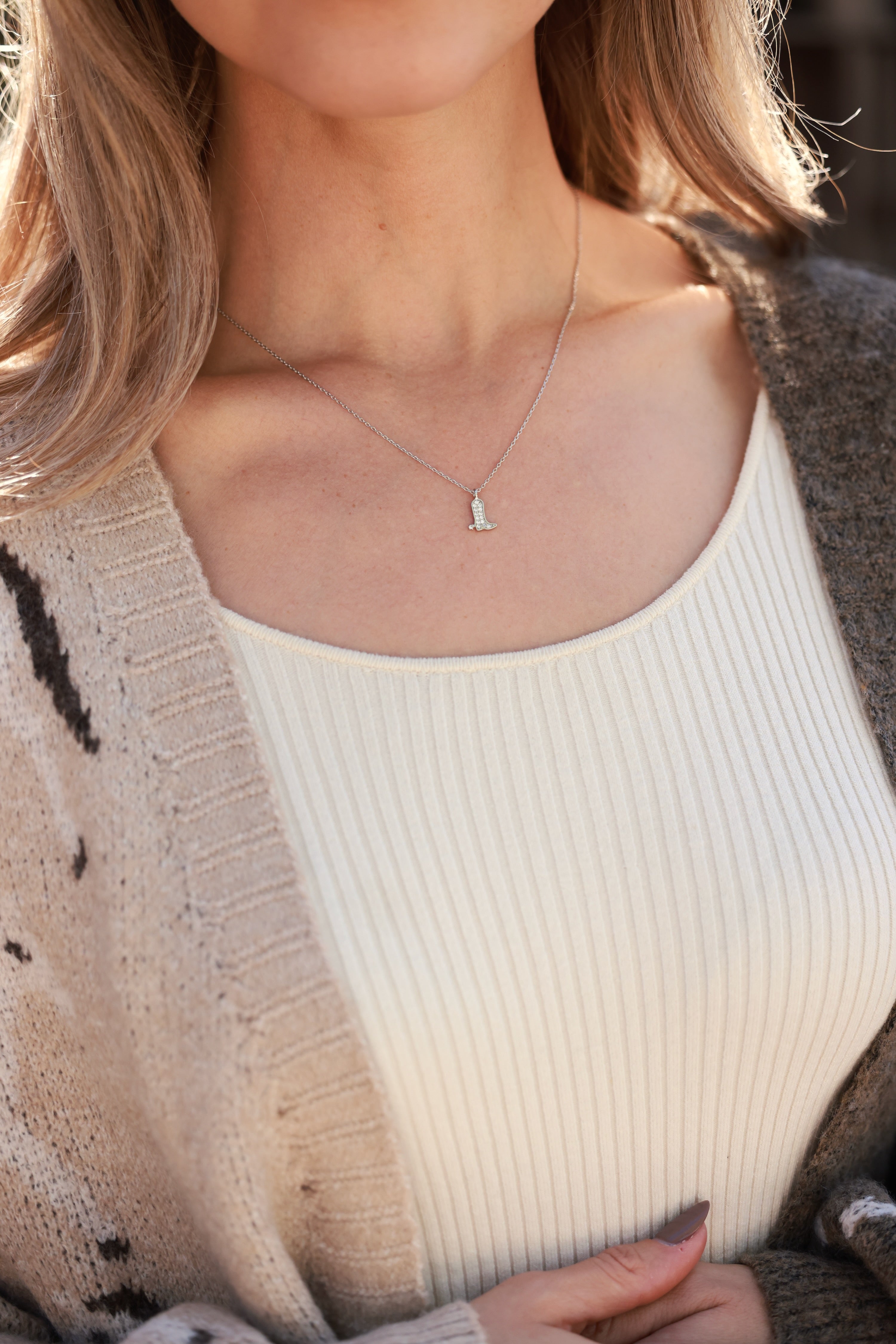Sadie Boot Necklace in sterling silver featuring a delicate chain with a tiny western boot charm adorned with CZ pavé detail. Dainty equestrian-inspired jewelry that adds a subtle sparkle — a perfect gift for horse lovers.