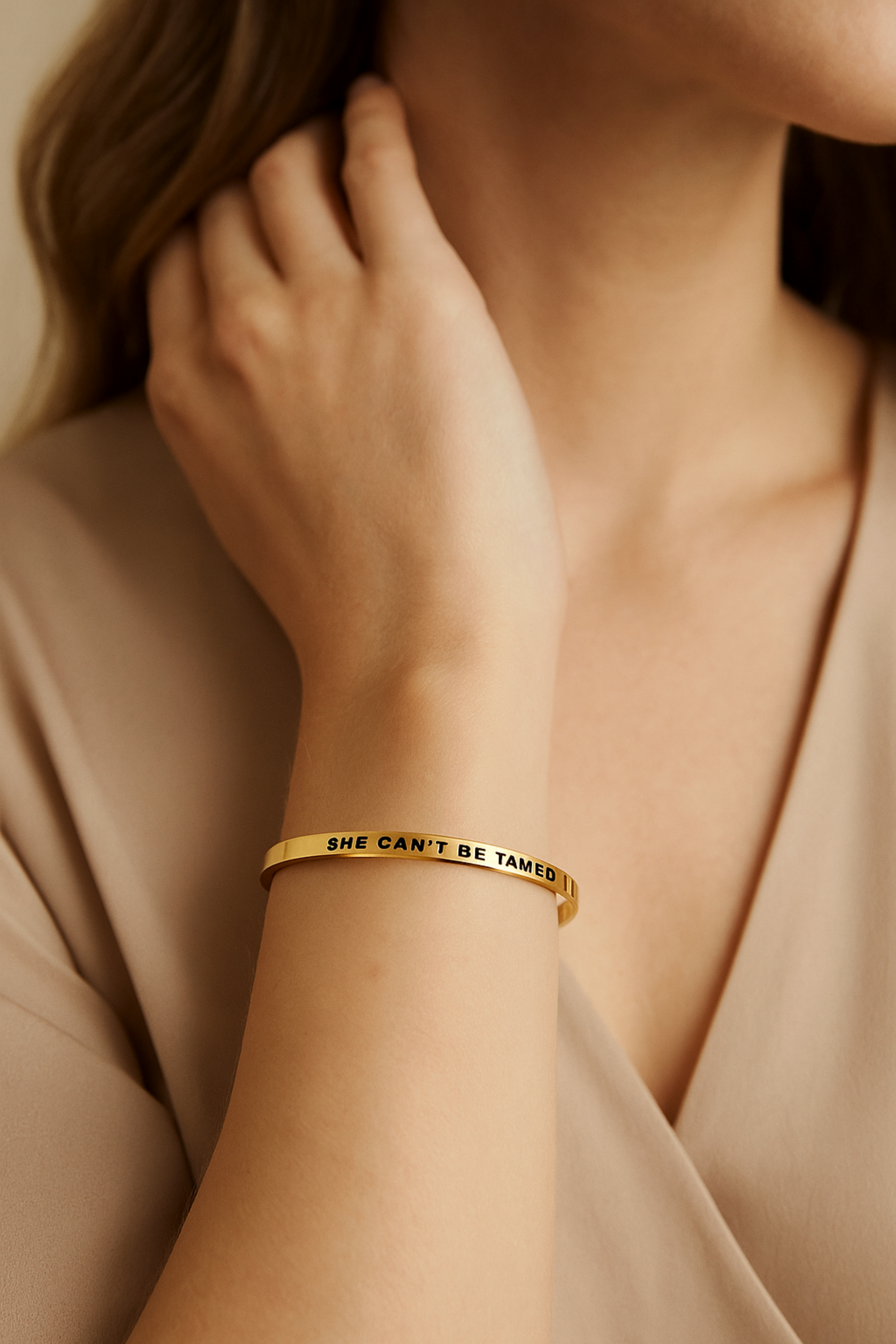 “She Can’t Be Tamed” bangle bracelet in silver or gold, crafted from stainless steel with an adjustable, tarnish-resistant finish. A bold equestrian-inspired accessory symbolizing strength and free spirit — perfect for horse lovers.