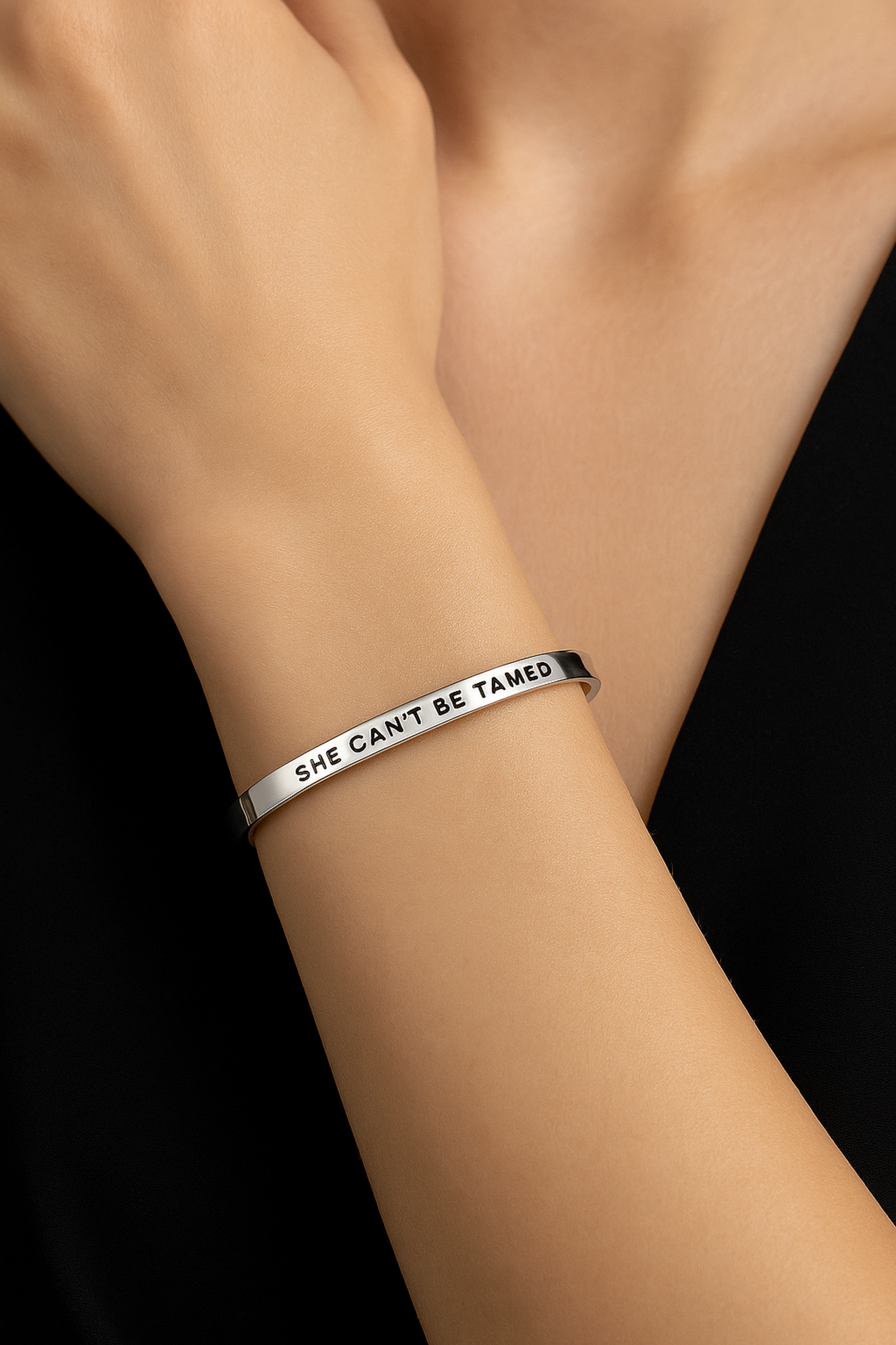 “She Can’t Be Tamed” bangle bracelet in silver or gold, crafted from stainless steel with an adjustable, tarnish-resistant finish. A bold equestrian-inspired accessory symbolizing strength and free spirit — perfect for horse lovers.