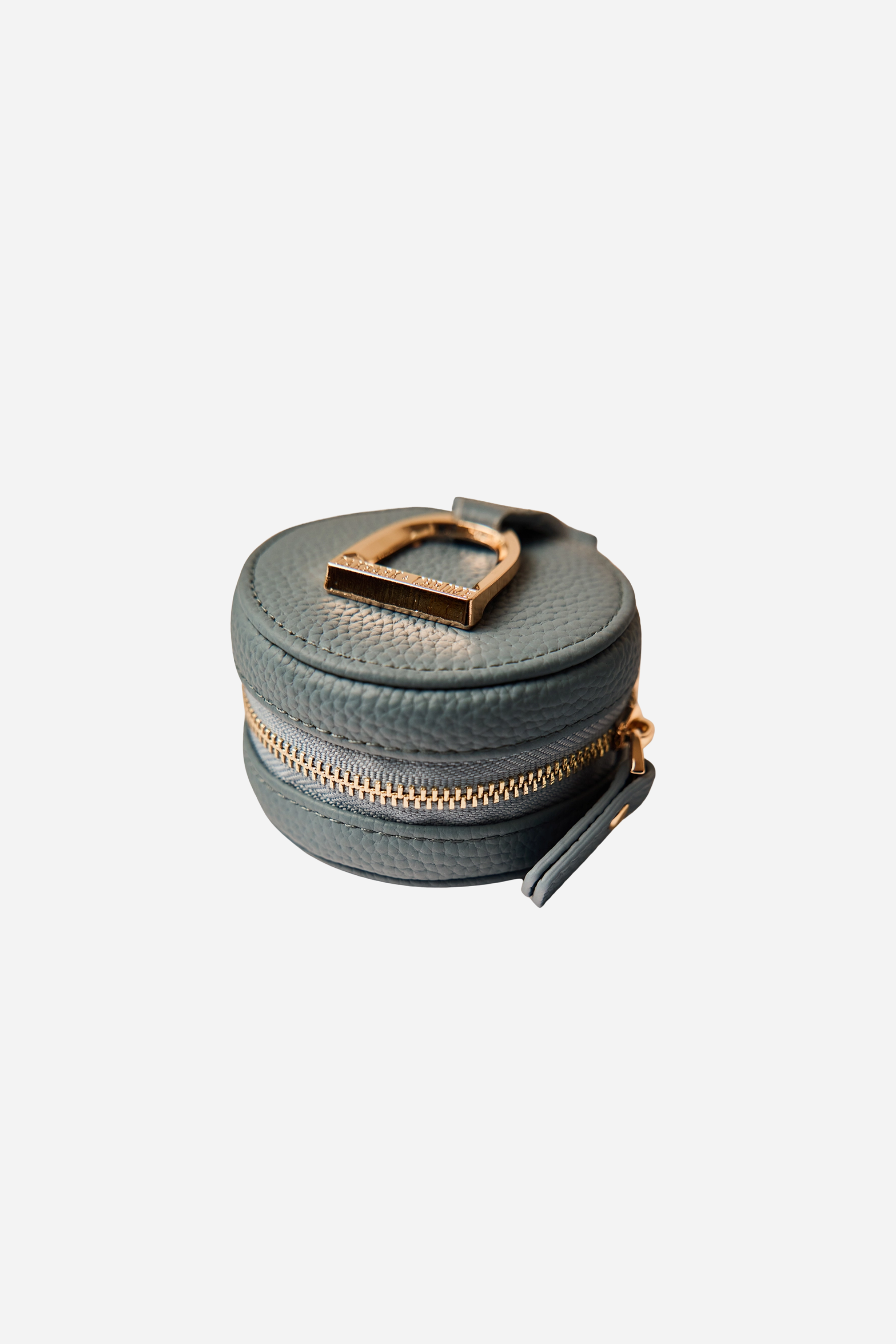 Equestrian pebbled leather AirPod case with a gold stirrup emblem, lobster clasp, and lined interior for easy attachment to bags.
