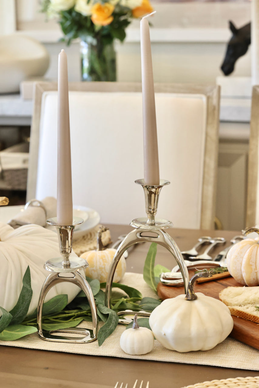 thg stylish equestrian silver stirrup candle stick holder set Silver Stirrup Candle Holder featuring a polished equestrian stirrup design that holds tapered candles. Available in small (6") and large (10") sizes, this elegant home accent adds refined equestrian charm to any space.