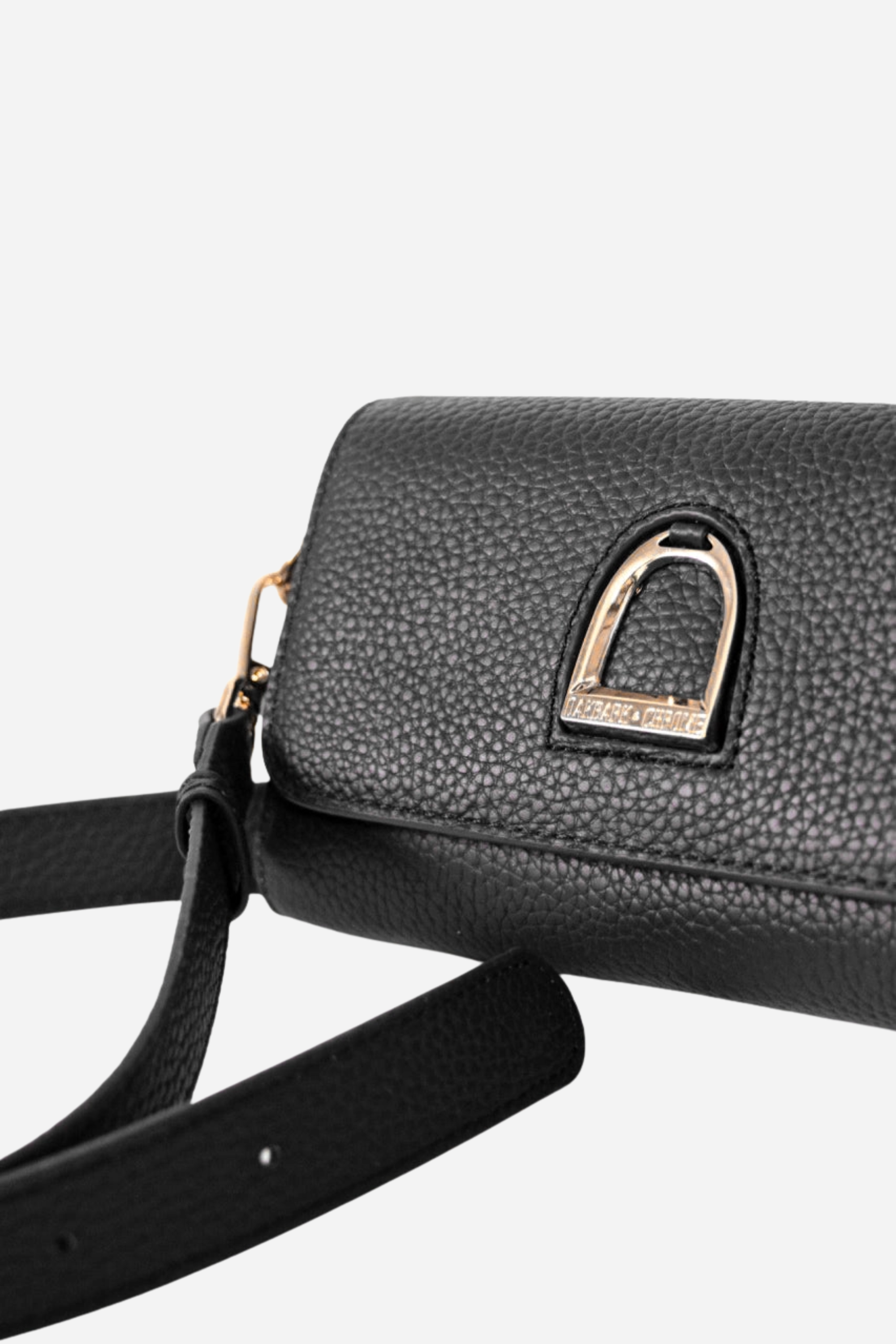 Oakbark & Chrome Stirrup Leather Belt Bag | A black leather clutch with a textured finish and gold accents. It features a gold clasp logo and a detachable wrist strap | Equestrian belt bag, black leather wristlet clutch, stirrup emblem purse, adjustable strap crossbody bag, pebbled leather belt bag, gold hardware equestrian bag, stylish horse girl accessory, small leather equestrian purse, Oakbark & Chrome belt bag, equestrian-inspired designer clutch