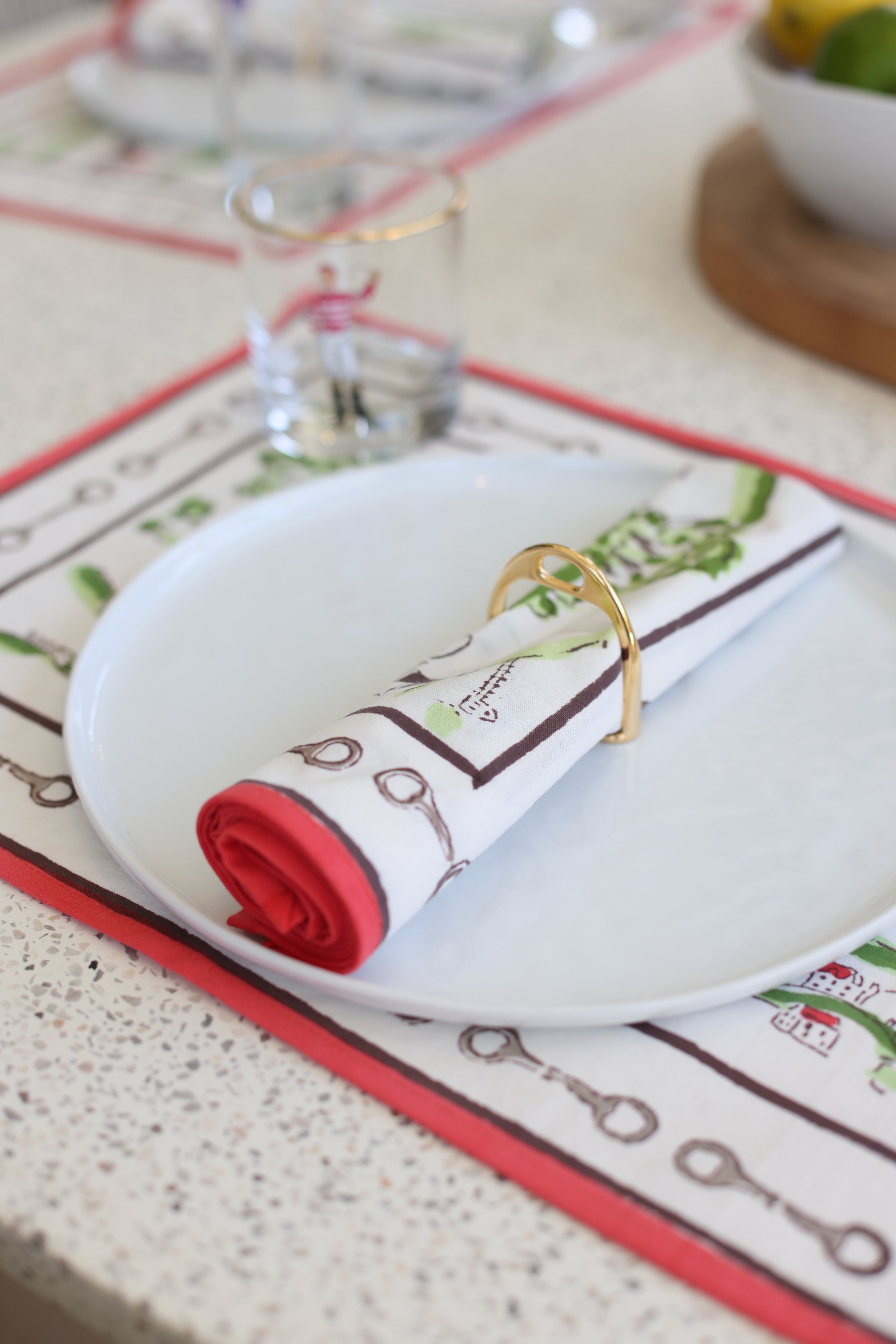 lilo collections stylish equestrian stirrup napkin ring set Gold Stirrup Napkin Ring Set featuring four polished brass stirrup-shaped rings with leather top closure for easy storage. Elegant equestrian-inspired table décor perfect for entertaining or gifting to horse lovers.