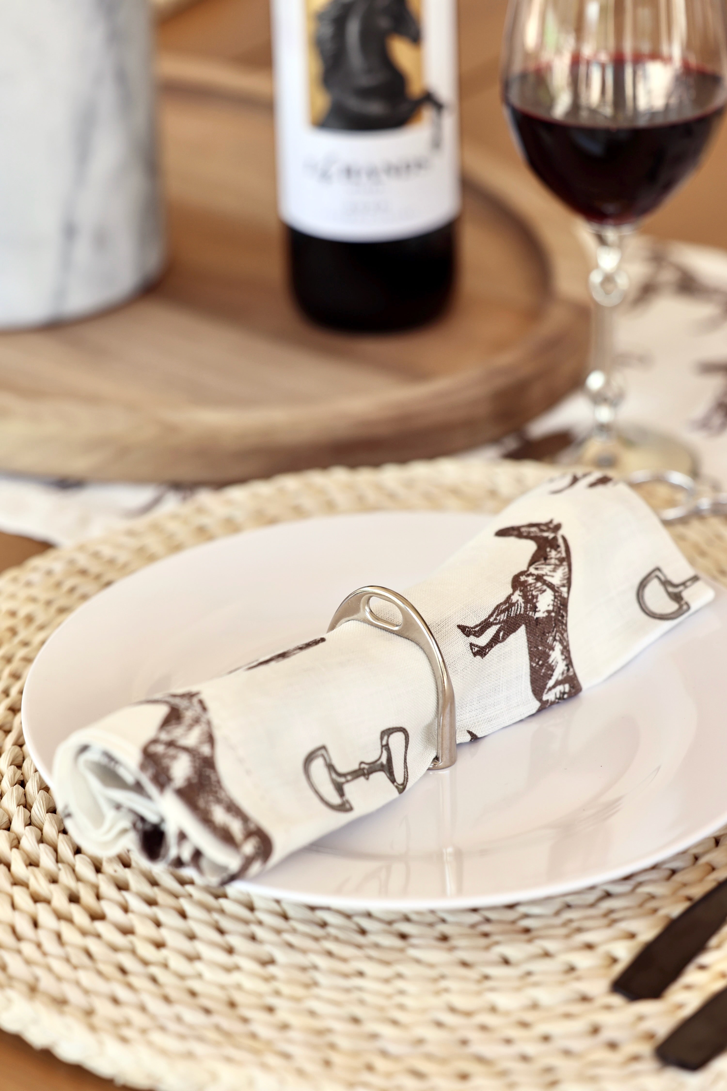 lilo collections stylish equestrian stirrup napkin ring set Silver Stirrup Napkin Ring Set featuring four polished silver stirrup-shaped rings with a leather top closure for easy storage. A best-selling equestrian-inspired table accessory perfect for elegant dining or gifting to horse lovers.