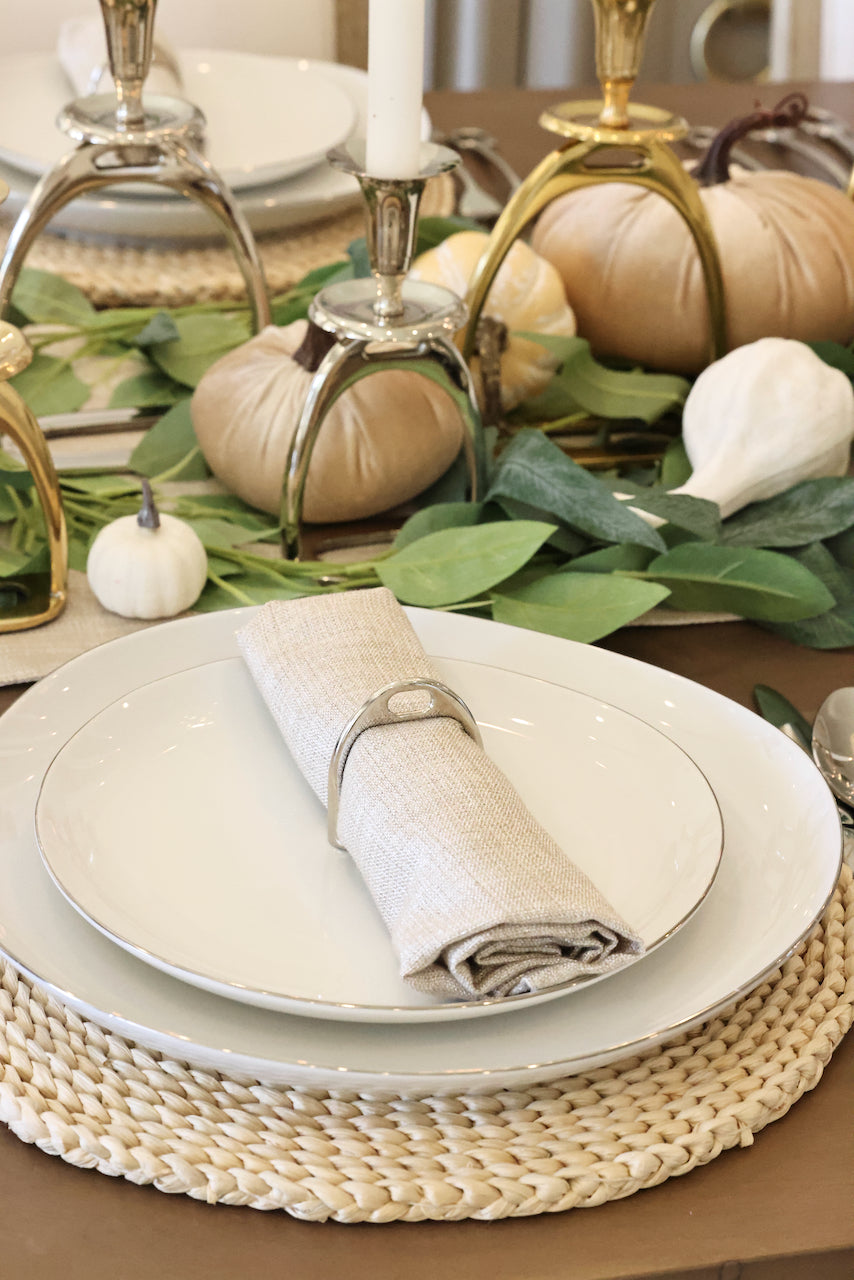 lilo collections stylish equestrian stirrup napkin ring set Silver Stirrup Napkin Ring Set featuring four polished silver stirrup-shaped rings with a leather top closure for easy storage. A best-selling equestrian-inspired table accessory perfect for elegant dining or gifting to horse lovers.