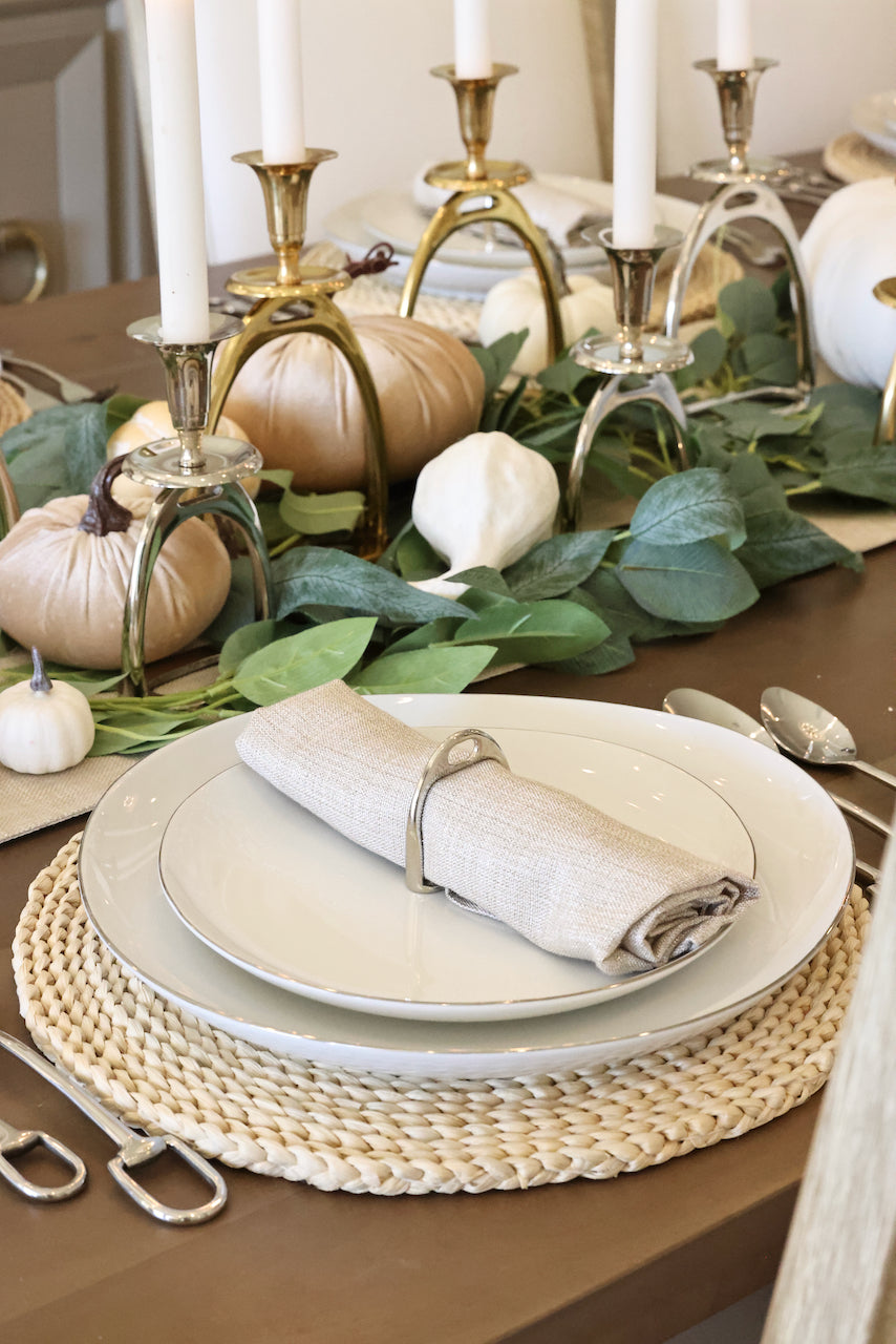 lilo collections stylish equestrian stirrup napkin ring set Silver Stirrup Napkin Ring Set featuring four polished silver stirrup-shaped rings with a leather top closure for easy storage. A best-selling equestrian-inspired table accessory perfect for elegant dining or gifting to horse lovers.