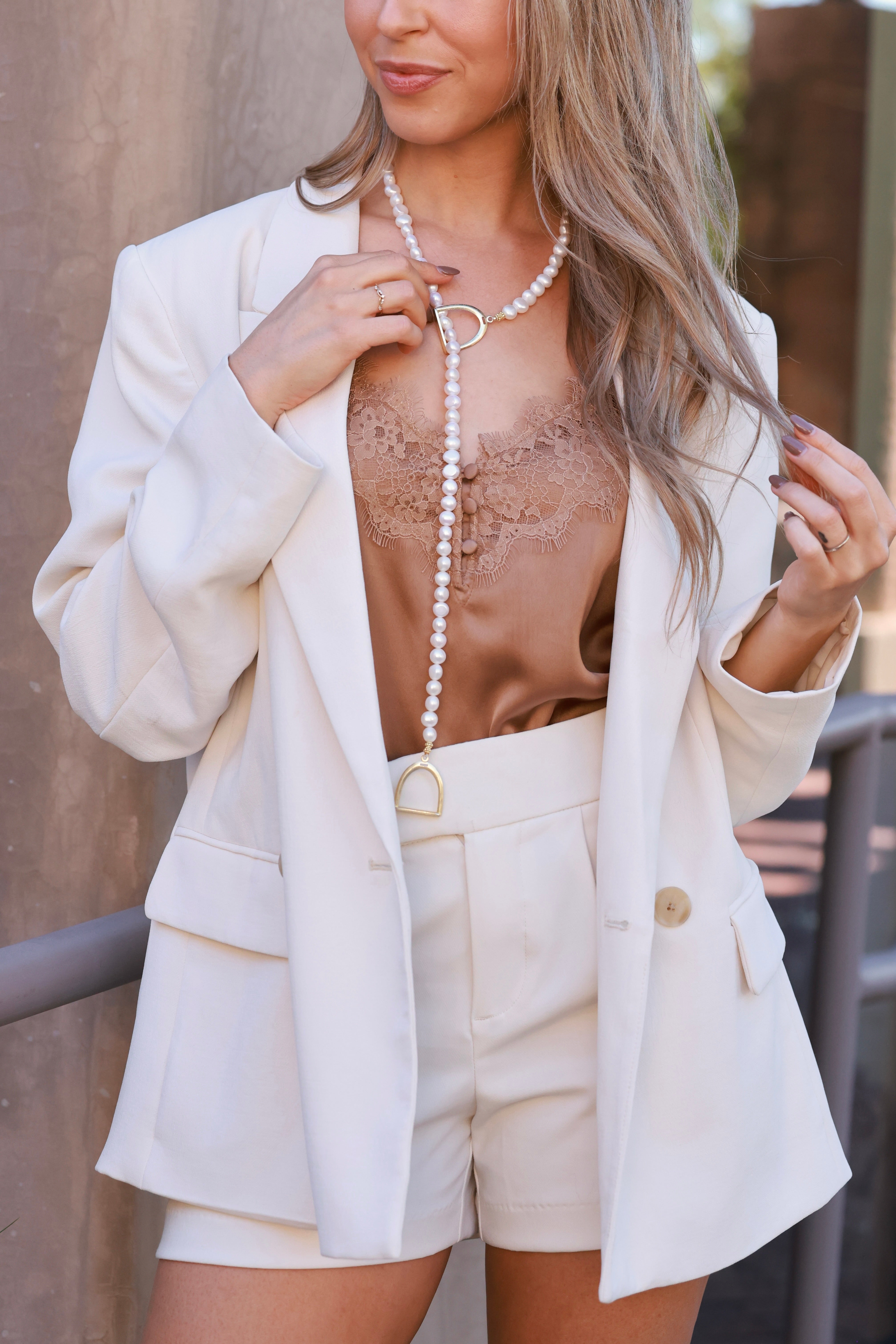 Stirrup Pearl Lariat Necklace with freshwater-style pearls and lightweight stirrup ends. Adjustable loop design, delicate and elegant for everyday wear.
