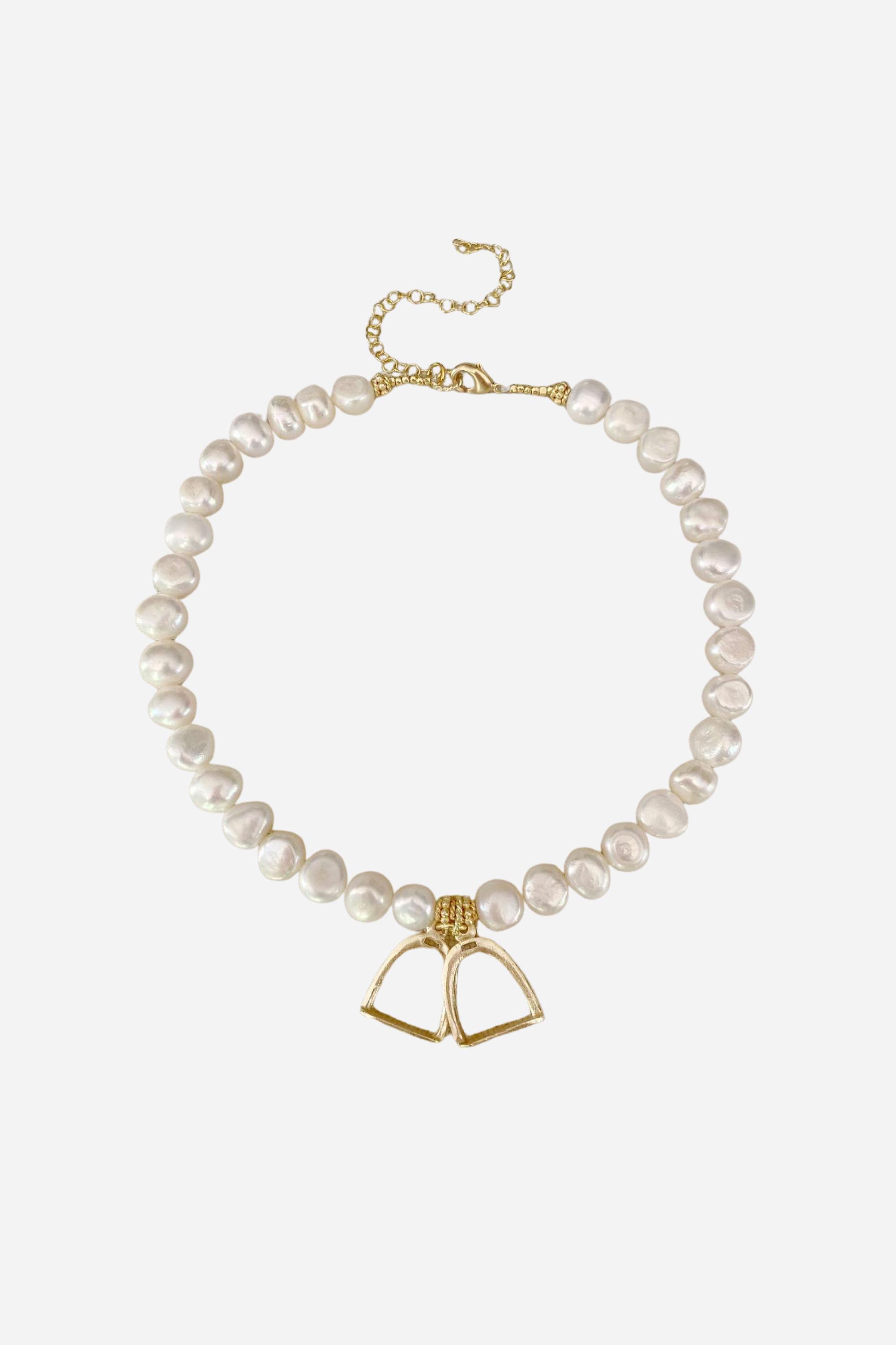 A refined fusion of equestrian charm and classic beauty. The Stirrup Pearl Necklace features lightweight stirrup accents delicately linked between lustrous pearls. Perfect for everyday elegance or layering. Measures 15" with an adjustable extender.