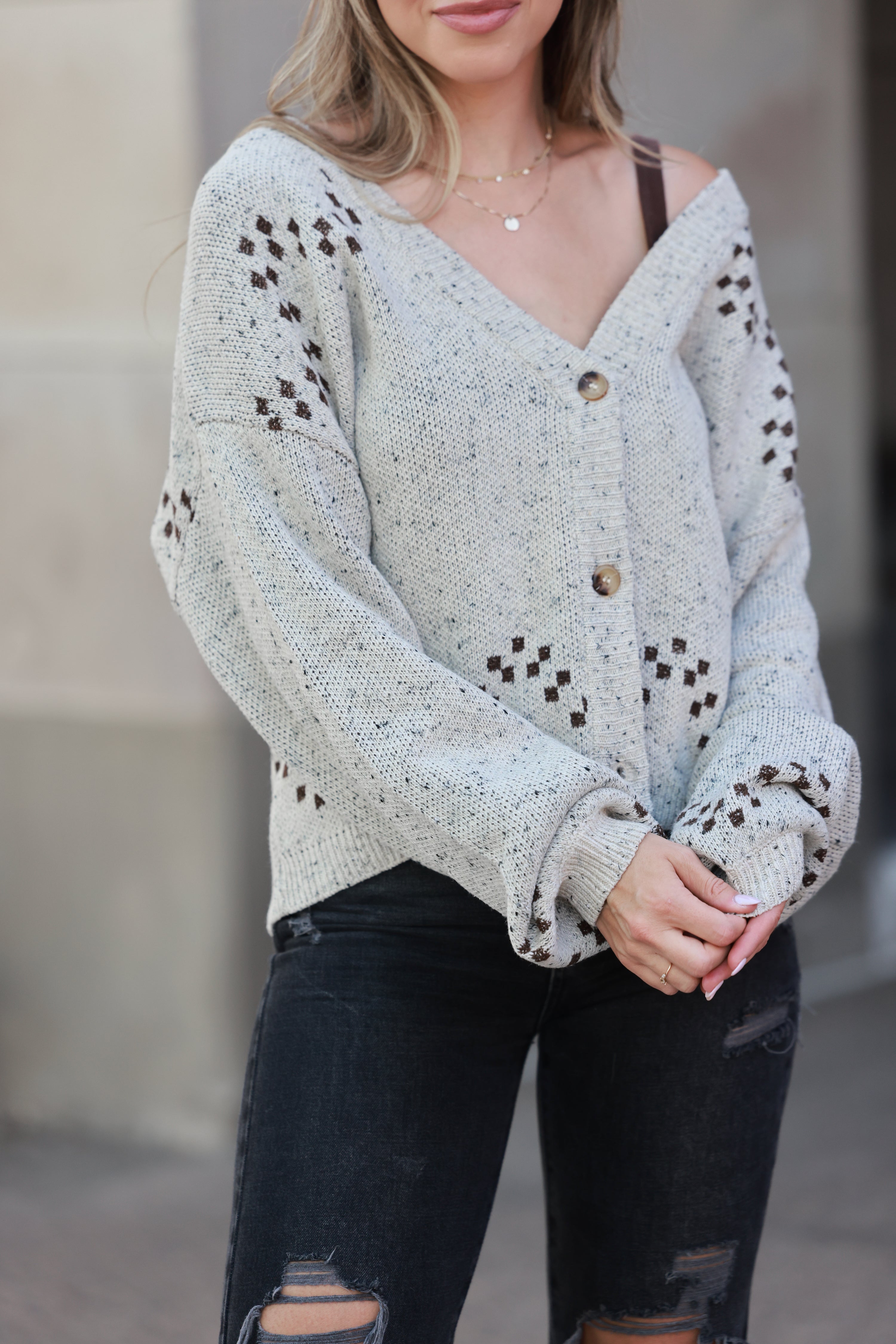 Woman wearing a light gray sweater with button details and black distressed - Horse graphic cardigan, Western button down sweater, Equestrian fall knit, Oatmeal horse print cardigan, Cowgirl boutique sweater jeans.