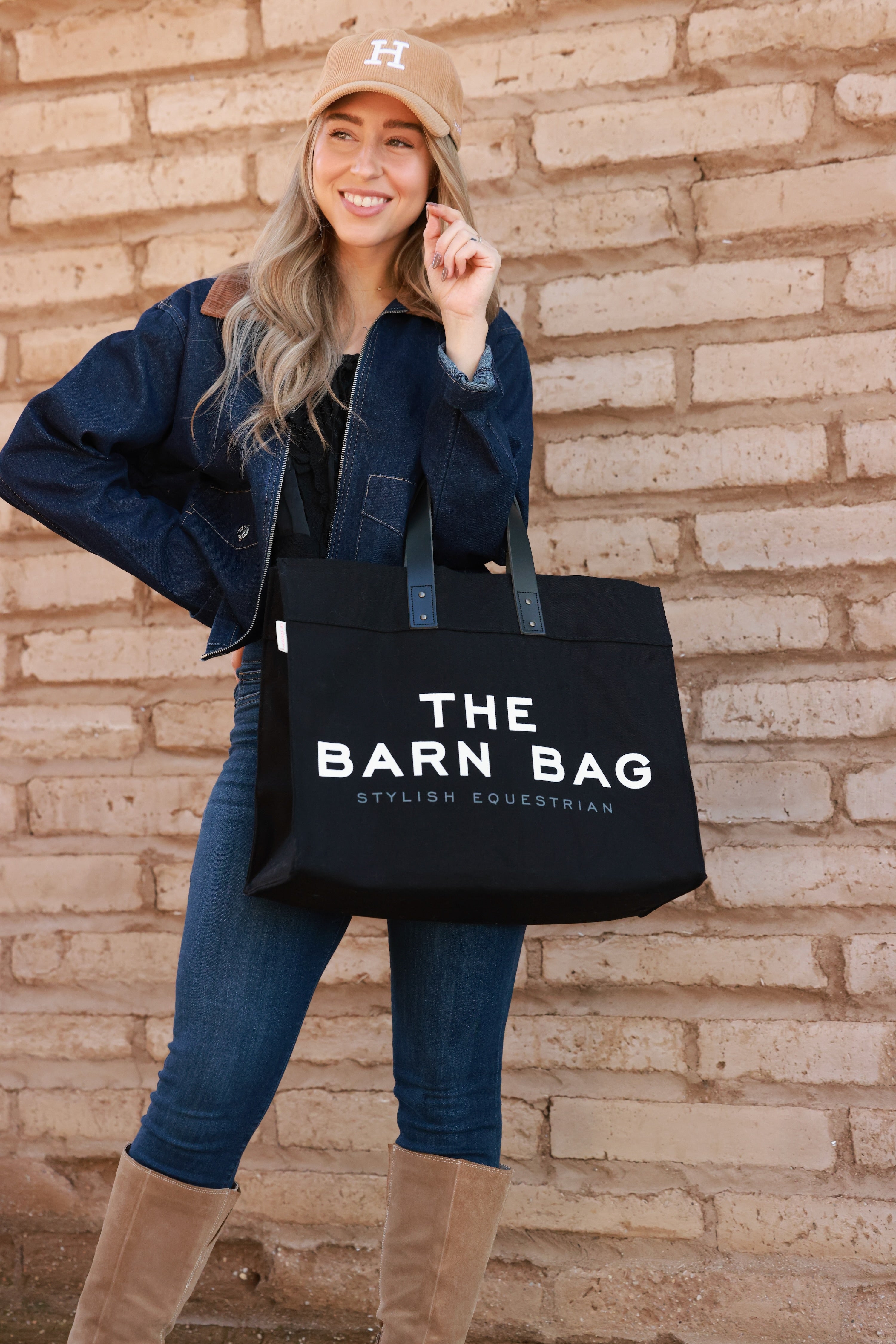 The Barn Bag Tote by Stylish Equestrian — durable canvas carry-all featuring cheeky front print, genuine leather handles, and two interior side pockets perfectly sized for a champagne bottle. Made in the USA, this equestrian-inspired tote is the ultimate barn and horse show essential.