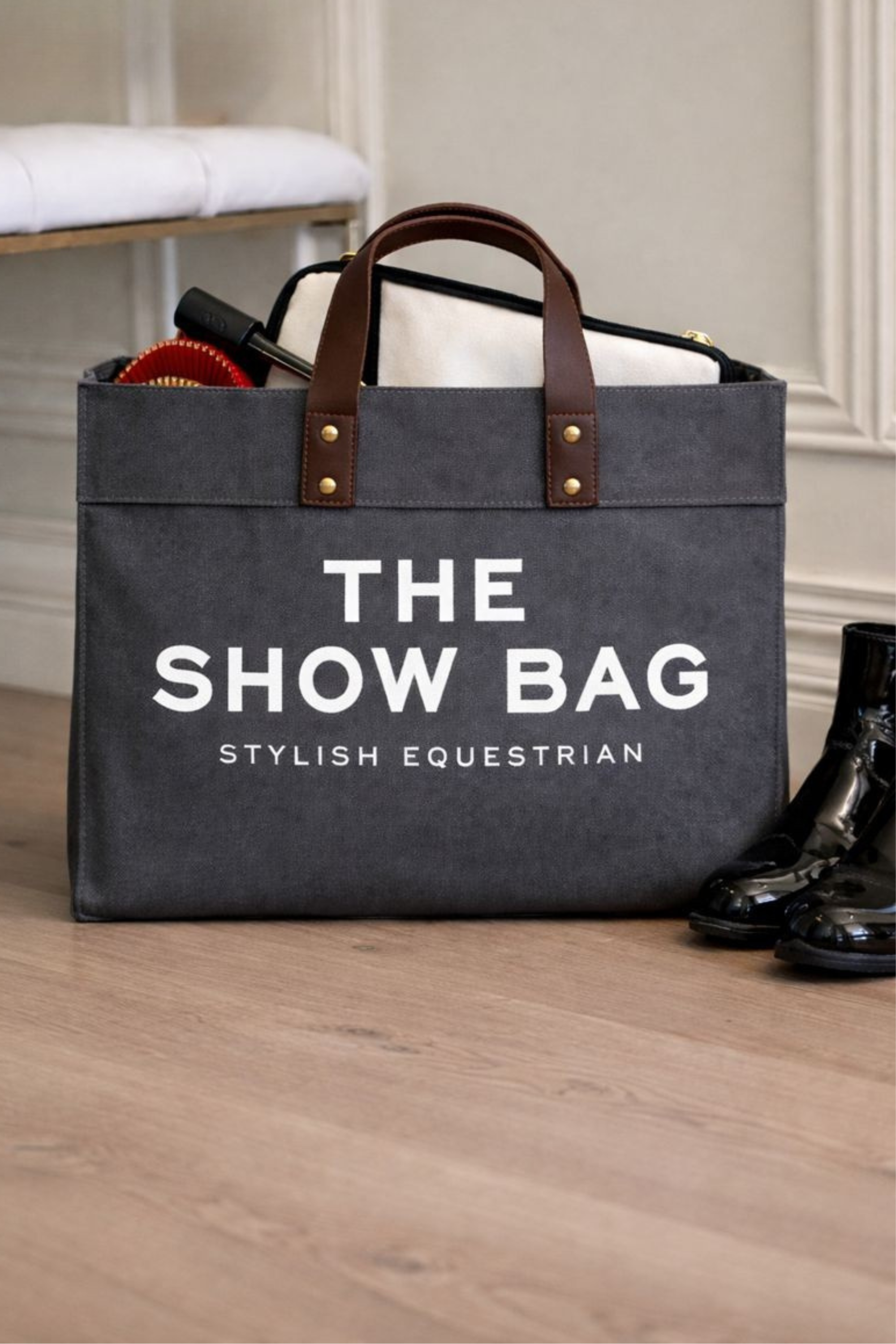 Canvas equestrian show bag tote with a cheeky front print, black leather handles, and spacious interior with side pockets for essentials.