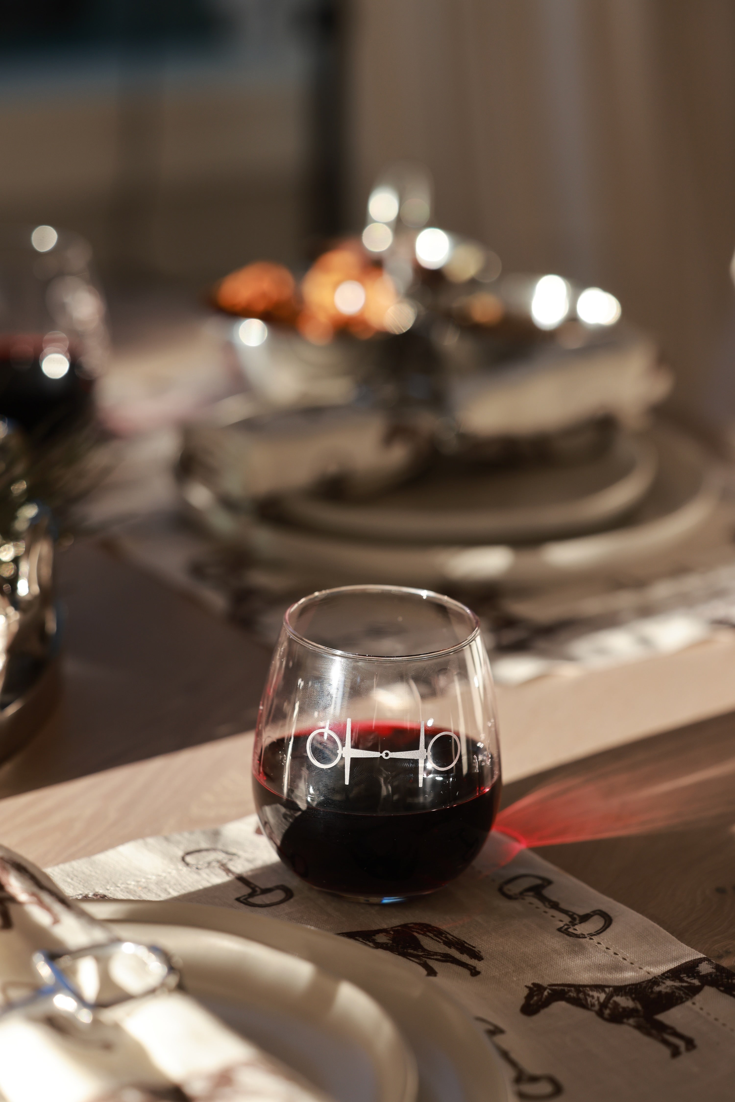 Troop of Horses Stemless Glass Set by Stylish Equestrian — elegant set of four 16 oz. stemless glasses, each hand-sandblasted with a unique horse bit design. Perfect equestrian-inspired glassware for entertaining, gifting, or home bar styling. Adds refined horse lover charm to any table setting. equestrian kitchen and dining, horse themed glassware, equestrian barware, horse bit wine glass set, luxury equestrian home decor, horse lover gift, elegant equestrian entertaining