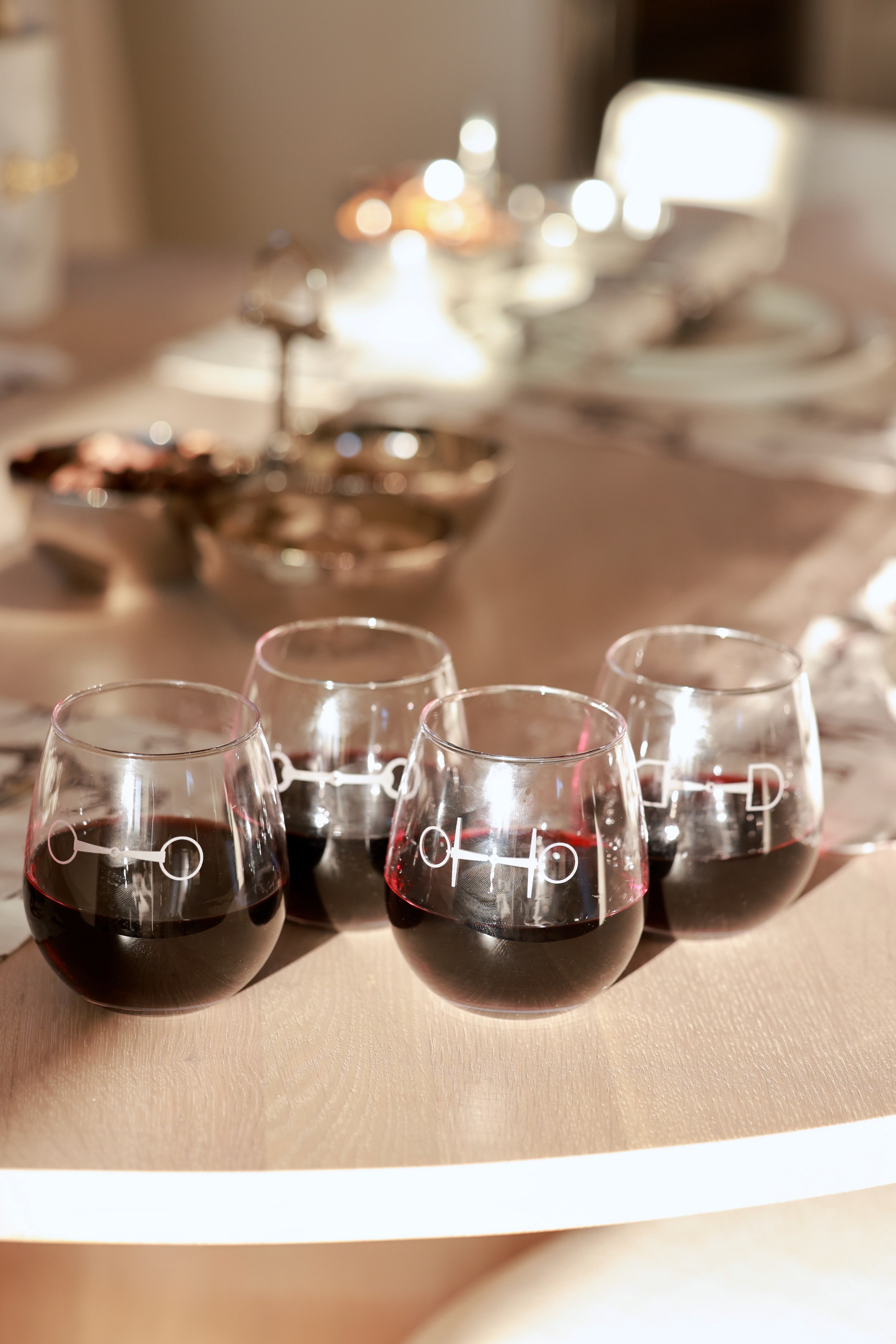 Troop of Horses Stemless Glass Set by Stylish Equestrian — elegant set of four 16 oz. stemless glasses, each hand-sandblasted with a unique horse bit design. Perfect equestrian-inspired glassware for entertaining, gifting, or home bar styling. Adds refined horse lover charm to any table setting. equestrian kitchen and dining, horse themed glassware, equestrian barware, horse bit wine glass set, luxury equestrian home decor, horse lover gift, elegant equestrian entertaining