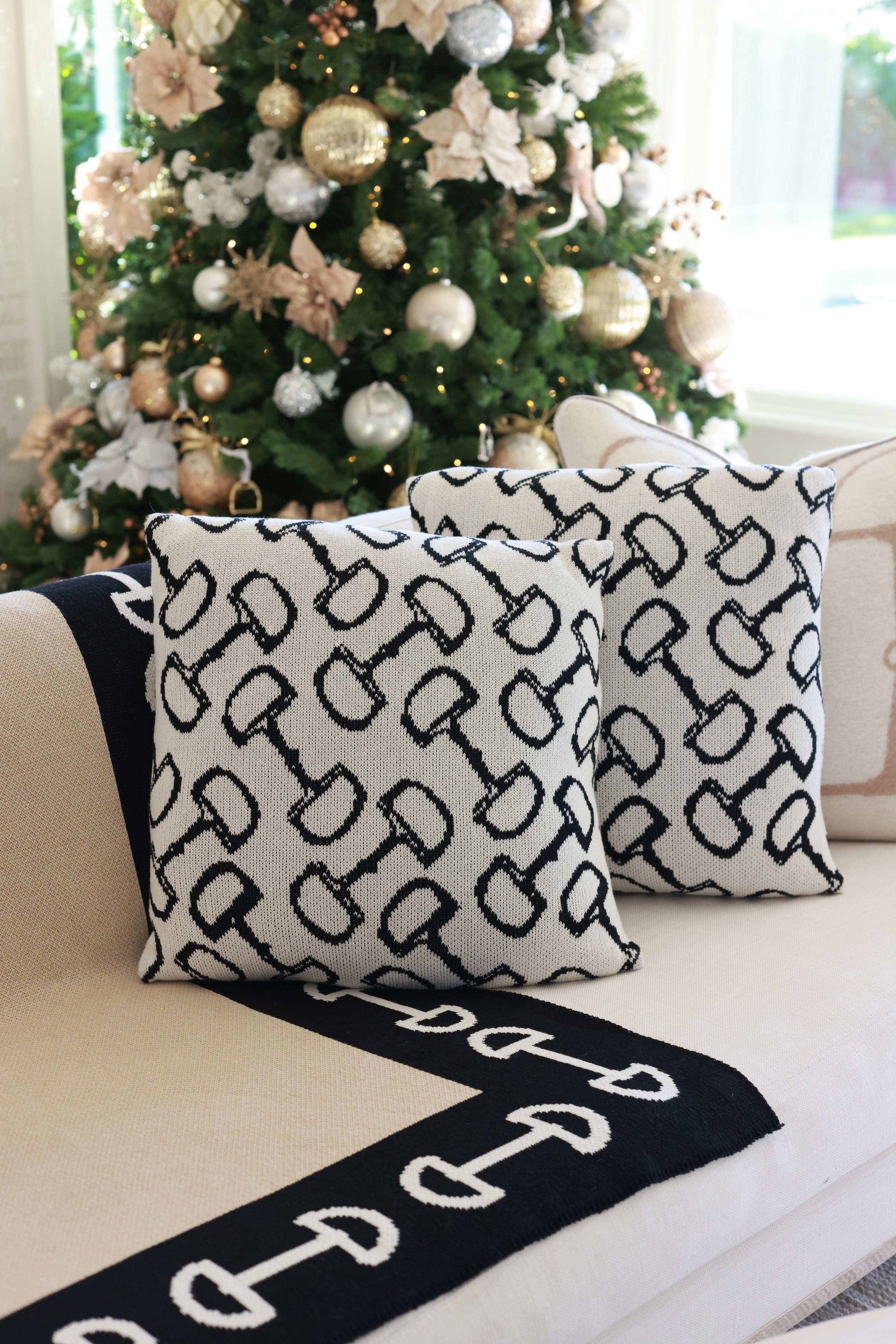 Twilight Pillow by Stylish Equestrian — a 20x20 luxury decorative pillow featuring a classic equestrian bit pattern in soft ivory and midnight black tones. Crafted from a plush cotton blend with insert included, this elegant home accent adds sophistication and comfort to any space. Made in the USA. equestrian home decor, horse themed pillow, luxury equestrian throw pillow, bit pattern cushion, equestrian living room decor, black and ivory pillow, horse lover home accents, elegant equestrian gift