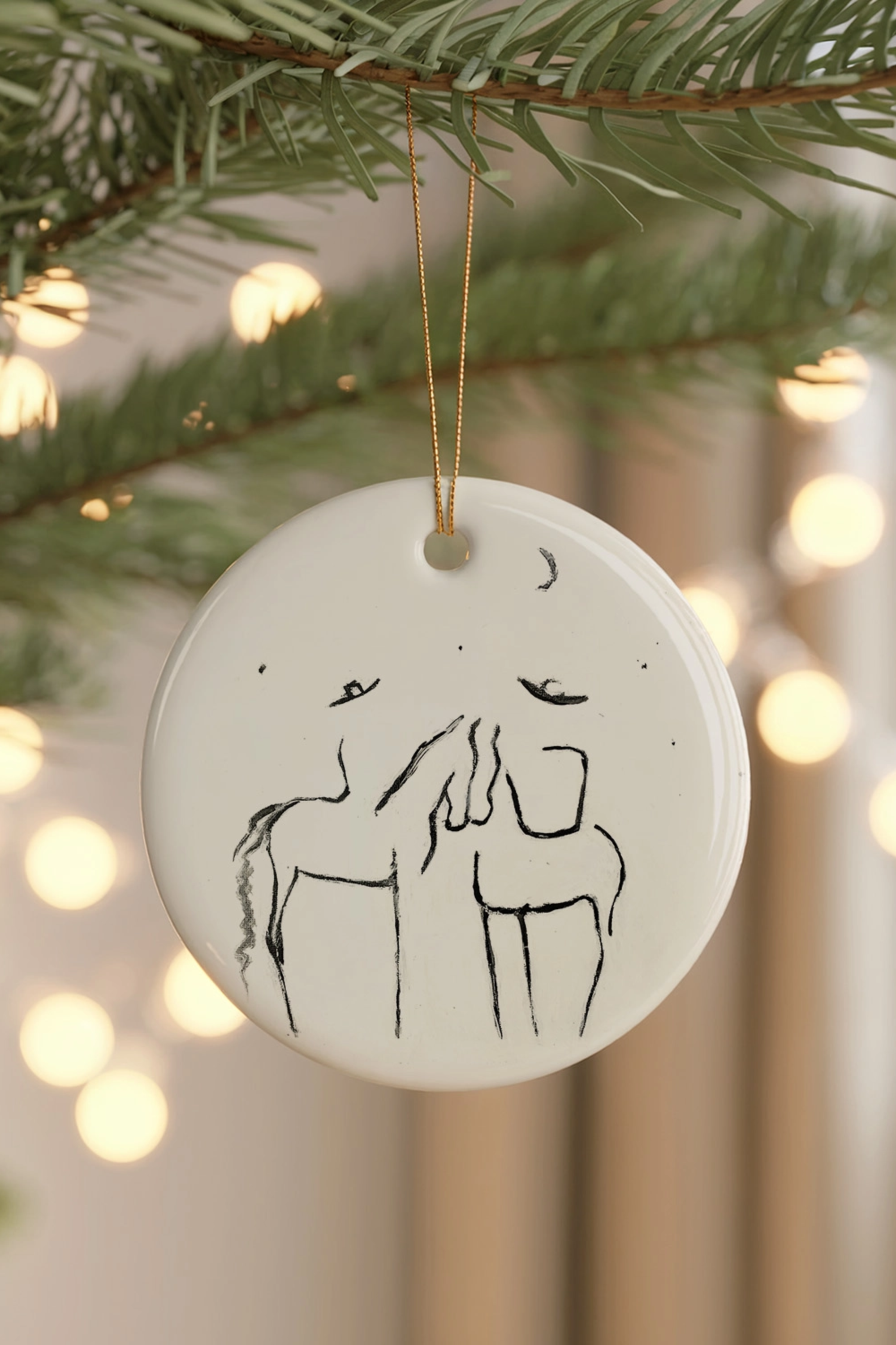 Under The Stars Ornament — ceramic equestrian-inspired Christmas ornament featuring original horse artwork by Bettina, strung with gold tinsel. Perfect horse-themed holiday gift for equestrians and horse lovers. Made in the USA.