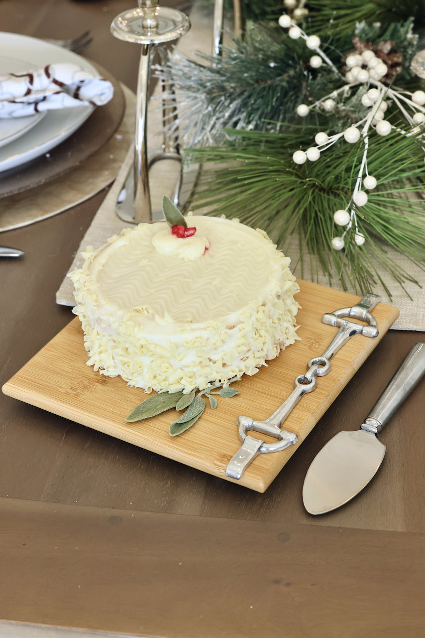 Well Served Set by Arthur Court featuring a bamboo serving board with a silver alloy horse bit accent, paired with a matching aluminum cheese knife and cracker tray. Elegant equestrian-themed serveware perfect for entertaining or gifting.
