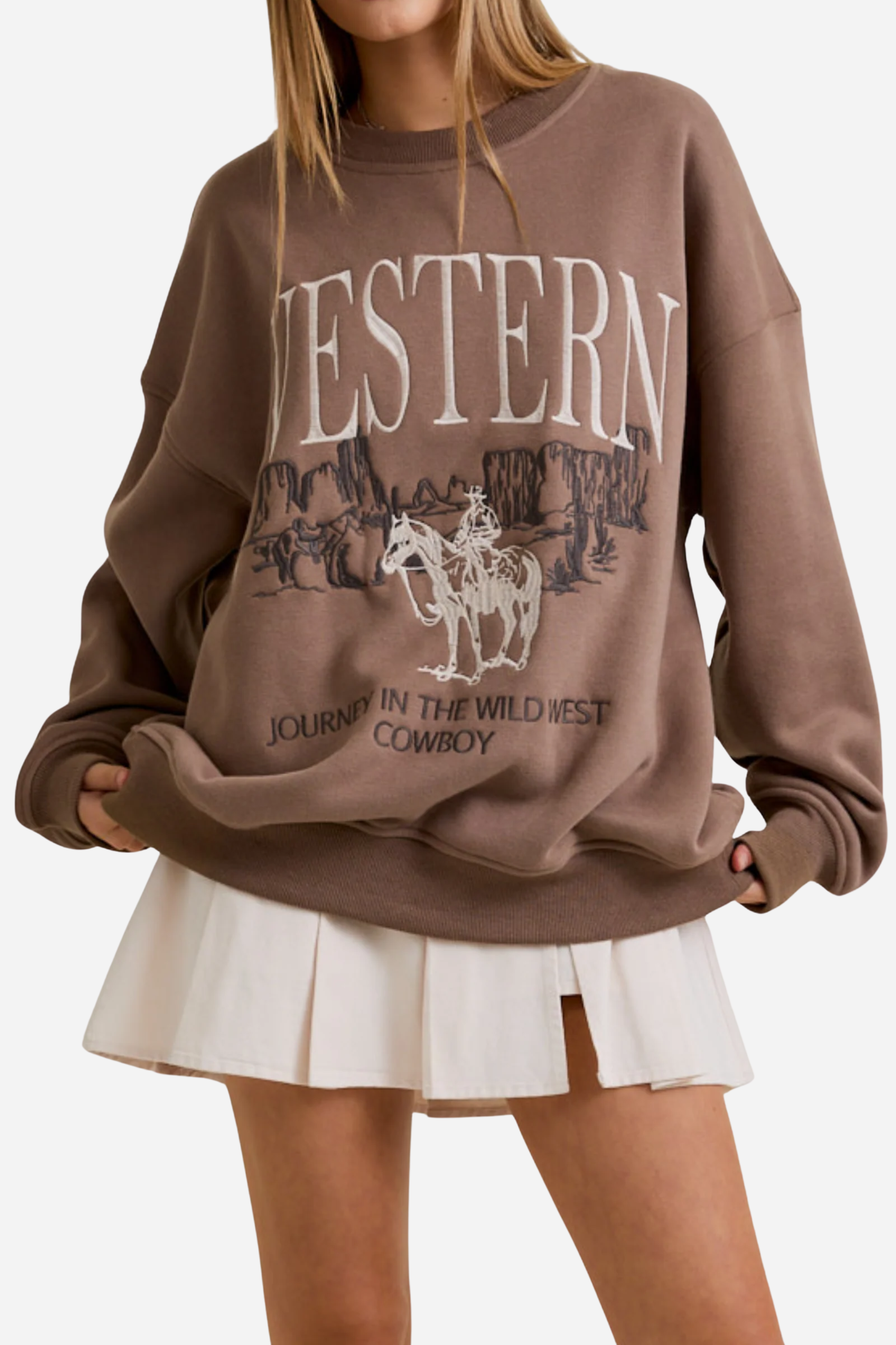 Brown sweatshirt with "WESTERN" in bold white letters, featuring an embroidered cowboy scene with cliffs. Text below reads, "JOURNEY IN THE WILD WEST COWBOY." western graphic sweatshirt, cowboy embroidered sweatshirt, women’s western fashion, vintage cowboy crewneck, casual western outfit, adventure inspired sweatshirt, bold western text sweater, wild west cowboy top, rustic western streetwear