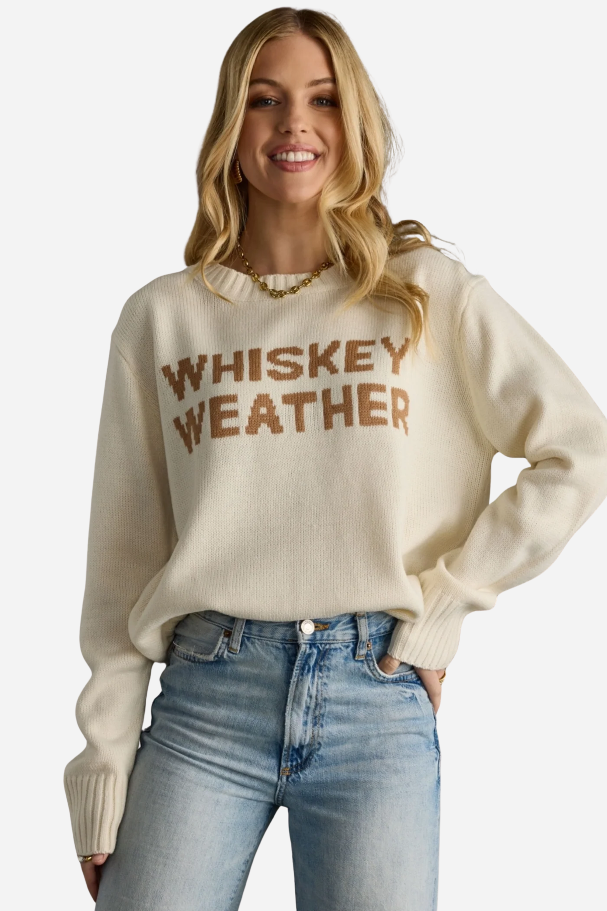 Woman wearing a beige sweater with 'WHISKEY WEATHER' text against a gray background - Whiskey weather sweater, Western graphic sweater, Fall country sweater, Ivory knit pullover, Cowgirl whiskey sweater