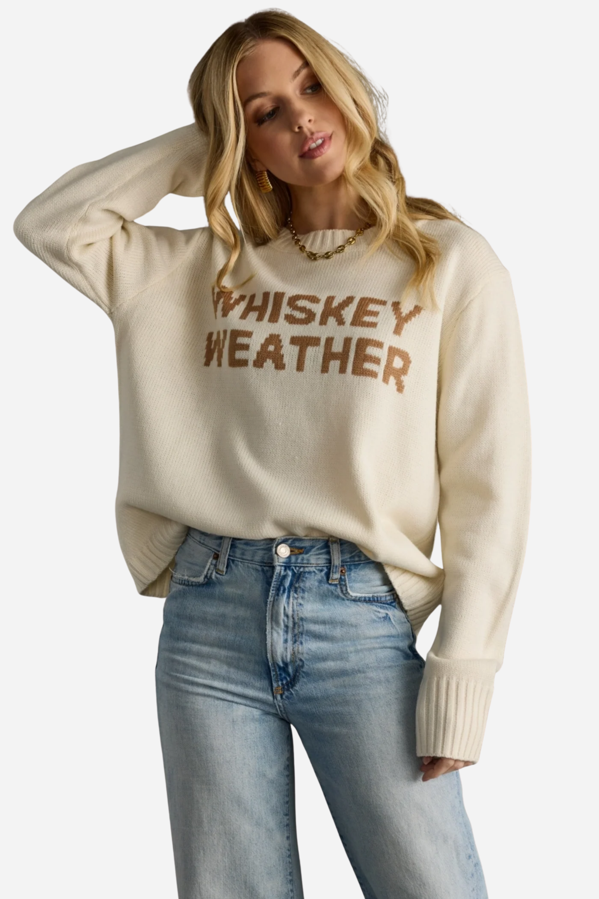 Woman wearing a beige sweater with 'WHISKEY WEATHER' text against a gray background - Whiskey weather sweater, Western graphic sweater, Fall country sweater, Ivory knit pullover, Cowgirl whiskey sweater