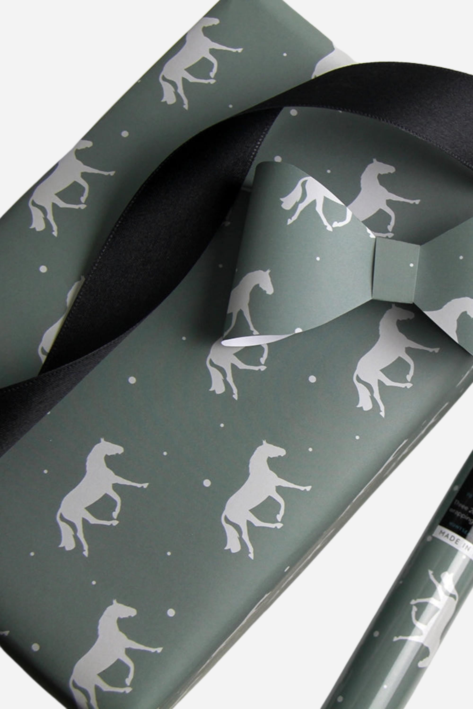 Set of three luxury equestrian gift wrap sheets featuring a repeating pattern of elegant trotting horses on a soft sage green background, printed on high-quality textured paper. Perfect horse themed wrapping paper for winter gifts, horse lovers, and equestrian events. Made in the USA. equestrian gift wrapping paper, horse wrapping paper, winter horse gift wrap sheets, sage green horse gift wrap, luxury horse themed wrapping paper, equestrian stationery, horse lover gift wrap, elegant equestrian