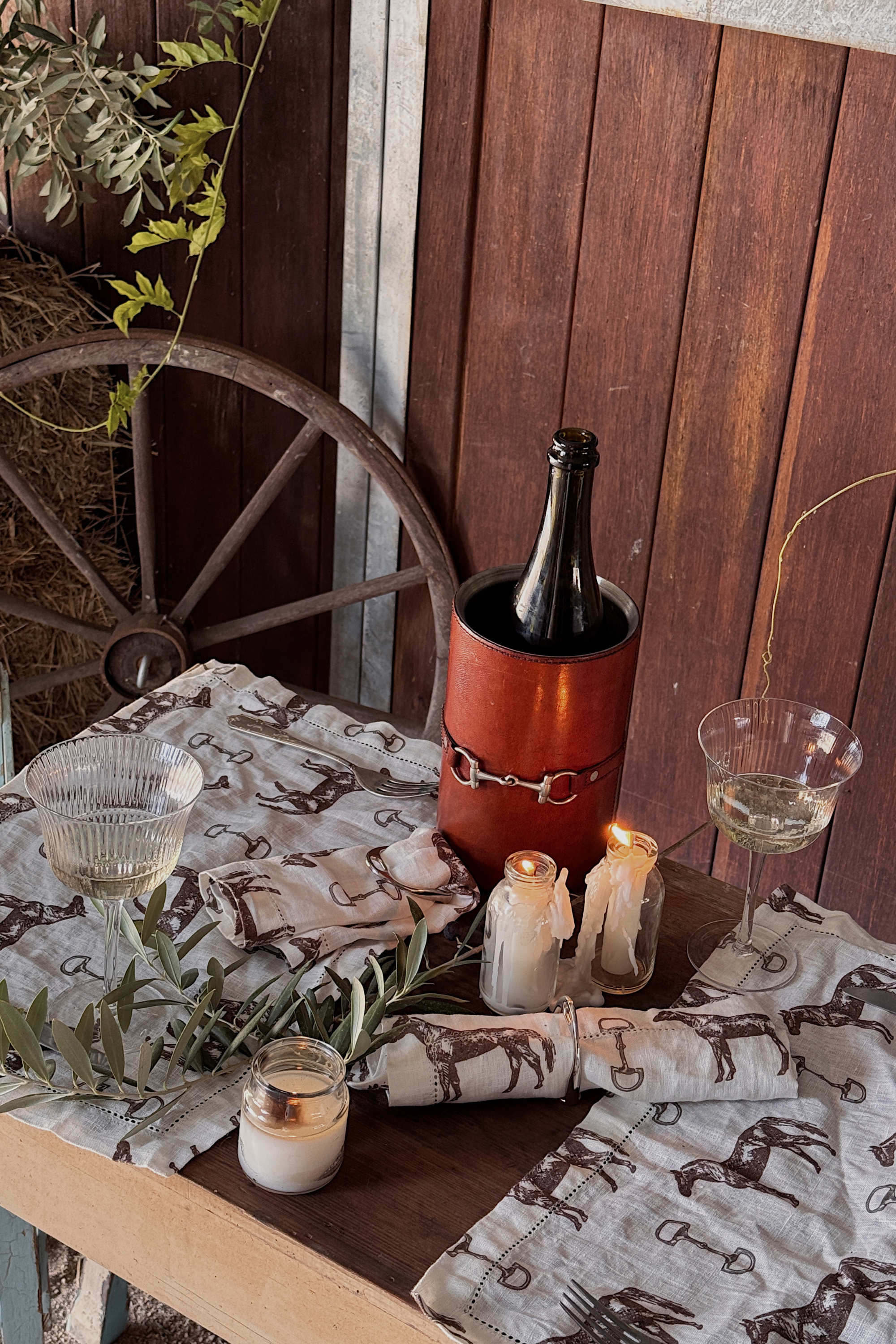 arthur court stylish equestrian horse bit leather wine bucket cooler Horse & Snaffle Linen Placemat Set featuring a hand-sketched design of horses and snaffle bits on white linen with a stitched border. Set of four elegant 13x19" placemats perfect for equestrian-inspired table settings.