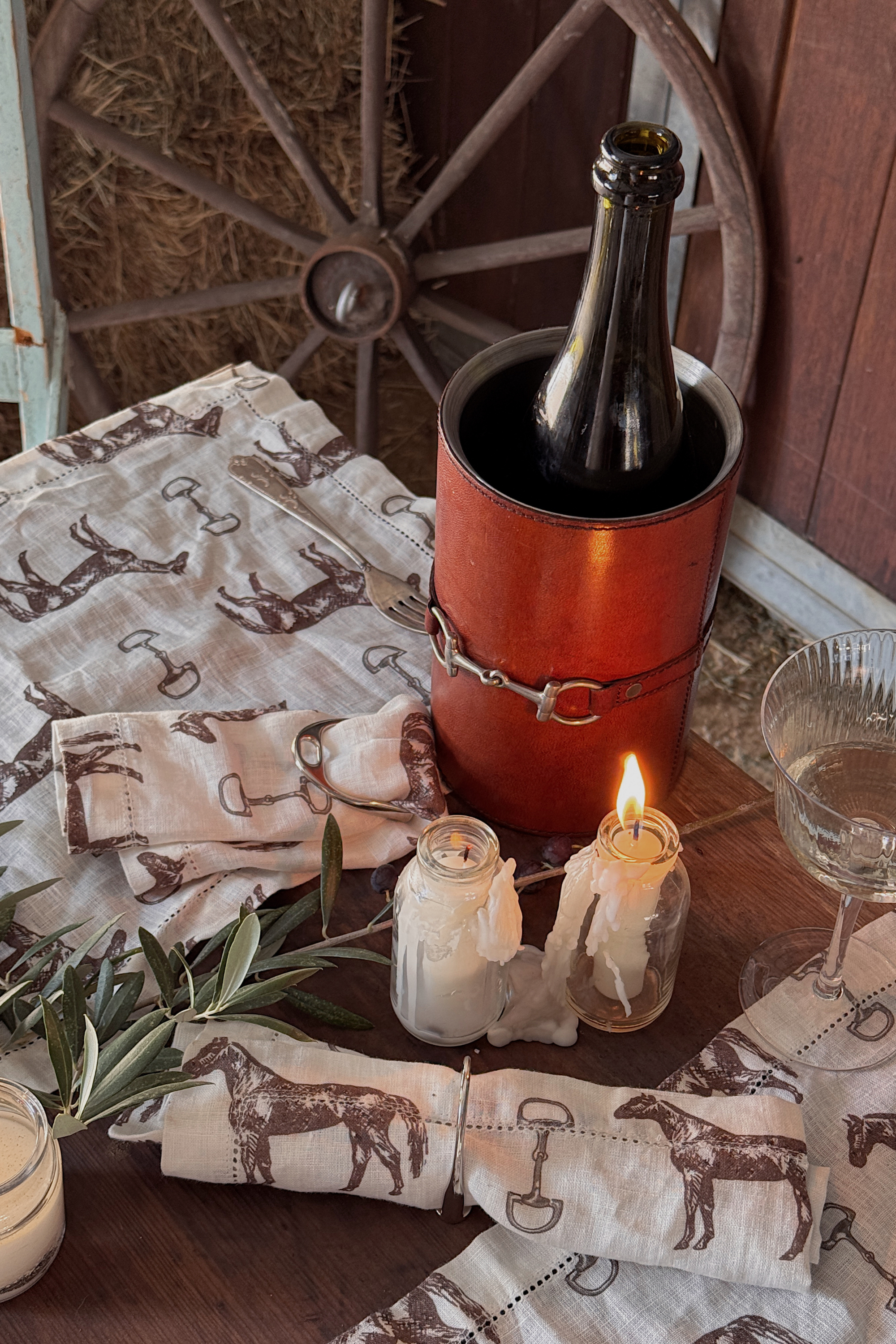 arthur court stylish equestrian horse bit leather wine bucket cooler Horse & Snaffle Linen Placemat Set featuring a hand-sketched design of horses and snaffle bits on white linen with a stitched border. Set of four elegant 13x19" placemats perfect for equestrian-inspired table settings.