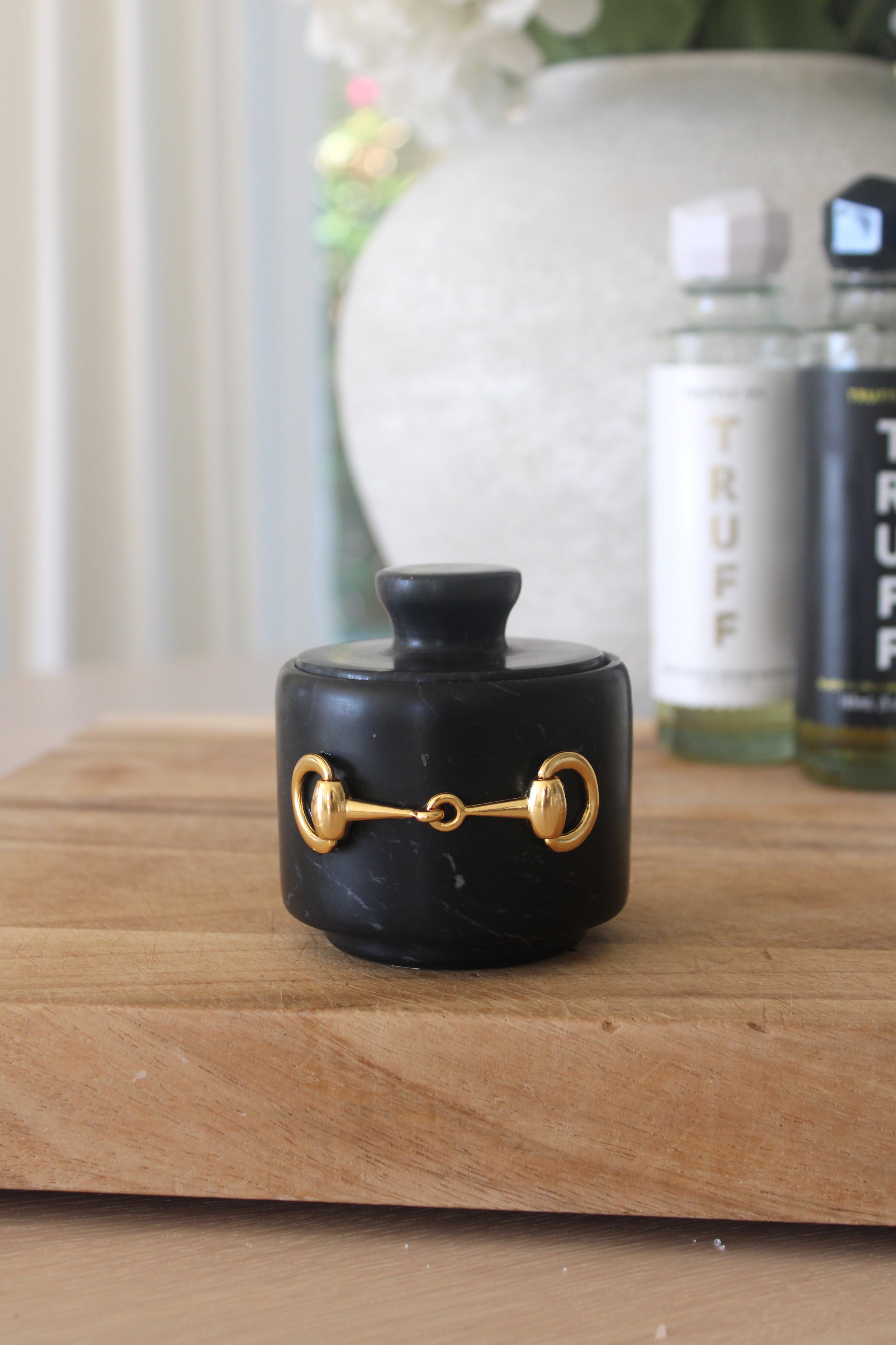 Elegant black marble D-ring salt cellar with gold hardware and matching lid, handcrafted for an equestrian-inspired kitchen. The round marble container features a sleek matte finish and natural veining, perfect for storing gourmet salts, spices, or herbs while adding sophisticated horse-themed decor to any table or countertop.