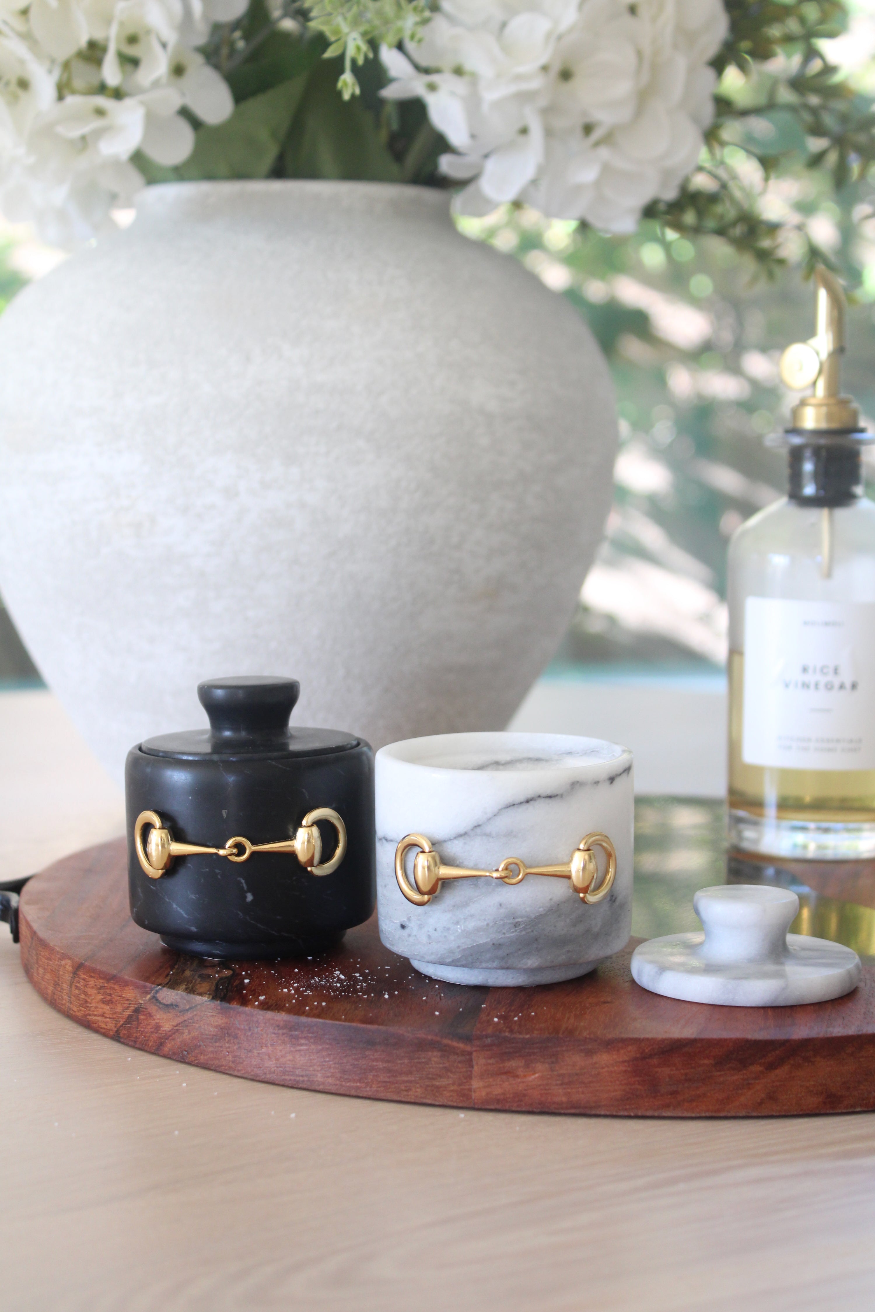 Elegant white marble D-ring salt cellar with gold hardware and matching lid, handcrafted for an equestrian-inspired kitchen. The round marble container features a sleek matte finish and natural veining, perfect for storing gourmet salts, spices, or herbs while adding sophisticated horse-themed decor to any table or countertop.