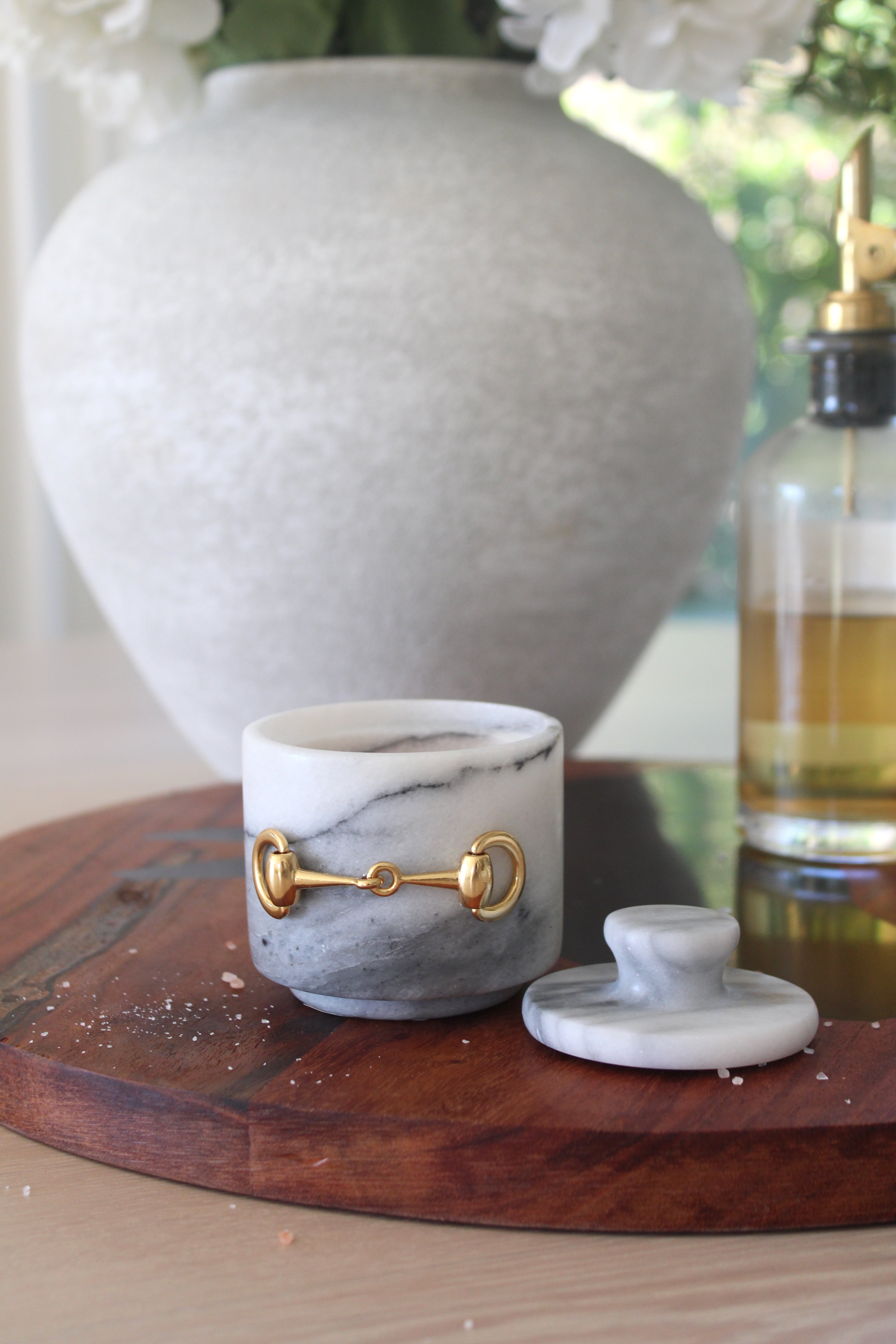 Elegant white marble D-ring salt cellar with gold hardware and matching lid, handcrafted for an equestrian-inspired kitchen. The round marble container features a sleek matte finish and natural veining, perfect for storing gourmet salts, spices, or herbs while adding sophisticated horse-themed decor to any table or countertop.