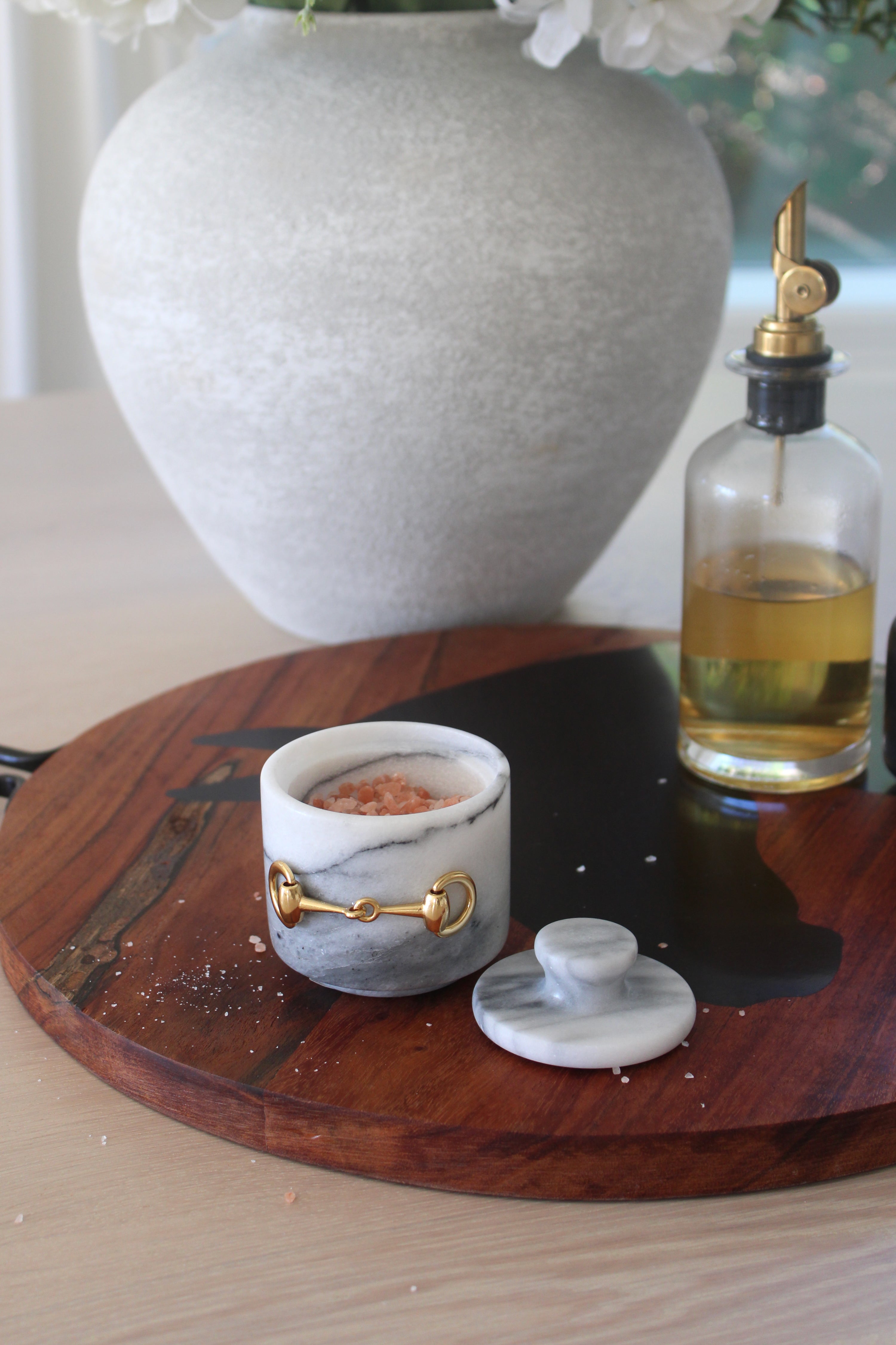 Elegant white marble D-ring salt cellar with gold hardware and matching lid, handcrafted for an equestrian-inspired kitchen. The round marble container features a sleek matte finish and natural veining, perfect for storing gourmet salts, spices, or herbs while adding sophisticated horse-themed decor to any table or countertop.