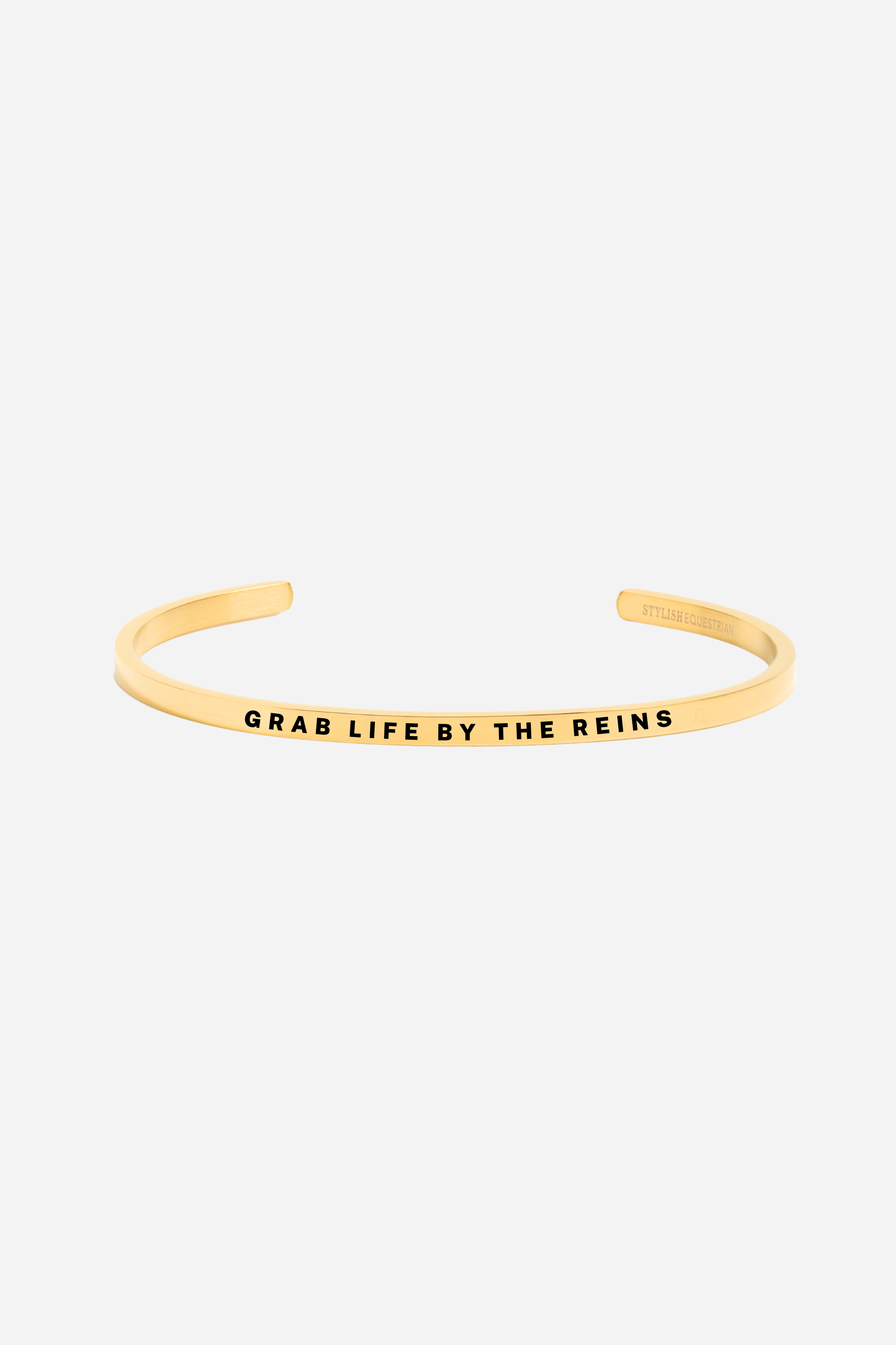 Grab Life By The Reins” bangle bracelet in silver or gold, featuring a sleek stainless steel design with an inspirational equestrian theme. Adjustable, tarnish-resistant, and perfect for horse lovers or as a motivational gift.