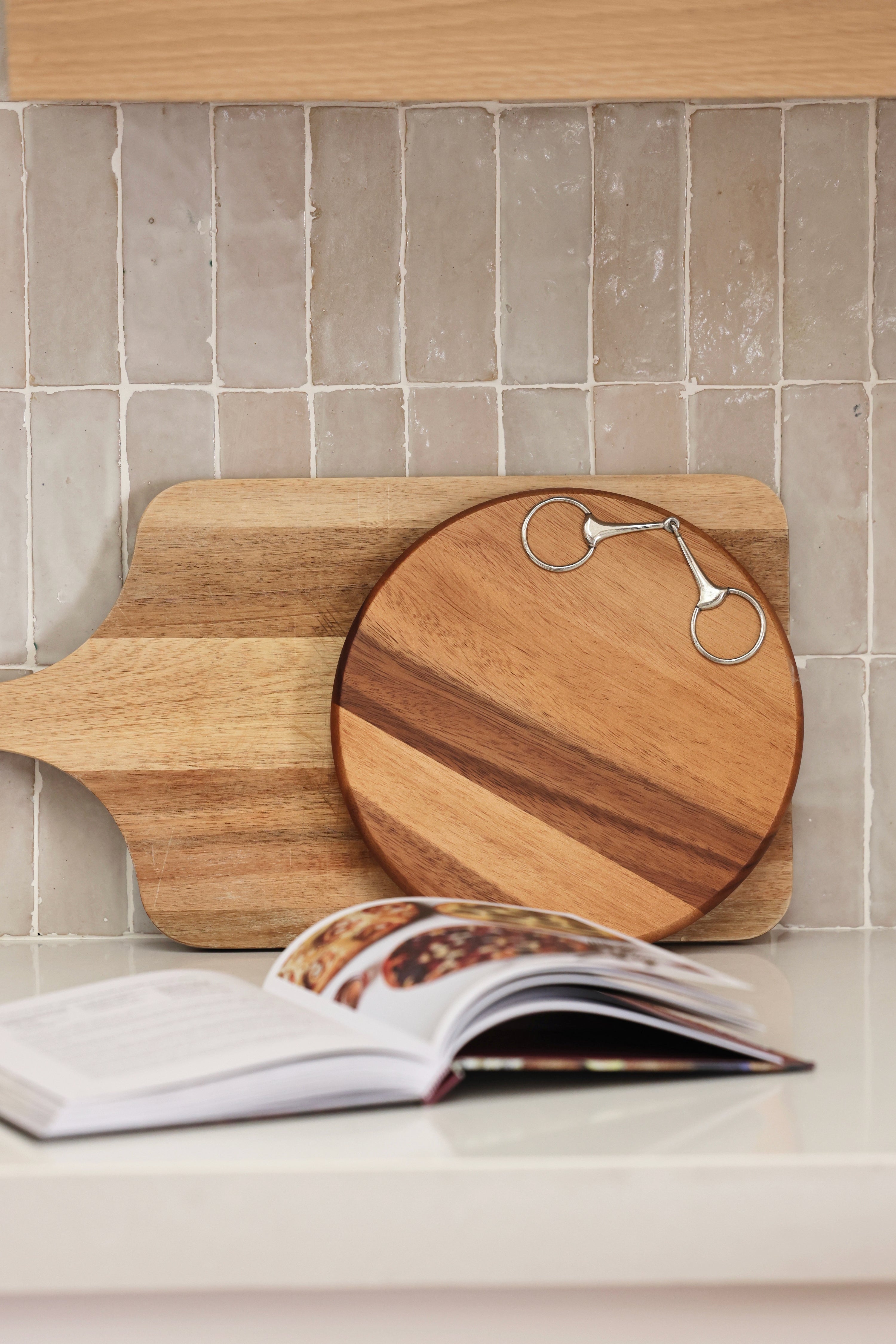 arthur court stylish equestrian henry wooden serving board horse bit Henry Bit Serving Board by Arthur Court featuring a round 10-inch acacia wood board accented with a pewter horse bit detail. A refined equestrian-inspired serving piece perfect for charcuterie, entertaining, or gifting.