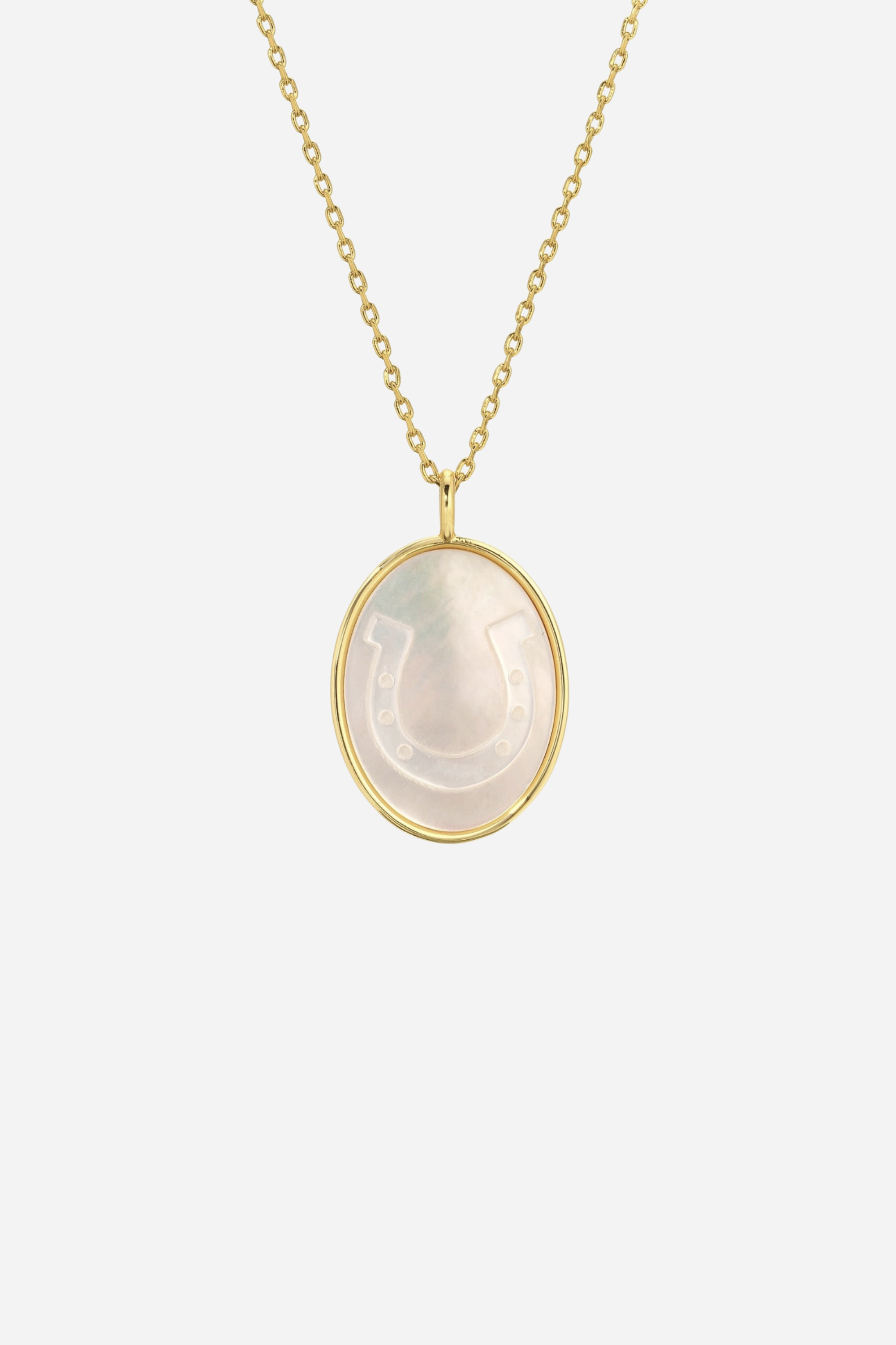 stylish equestrian splendid iris lucky cowgirl etched shell mother of pearl necklace Lucky Cowgirl Necklace featuring a delicate gold-framed pendant with an intricately etched horseshoe design set in luminous mother-of-pearl. 18-inch plated brass chain with .95-inch pendant — a dainty equestrian-inspired accessory perfect for horse lovers.