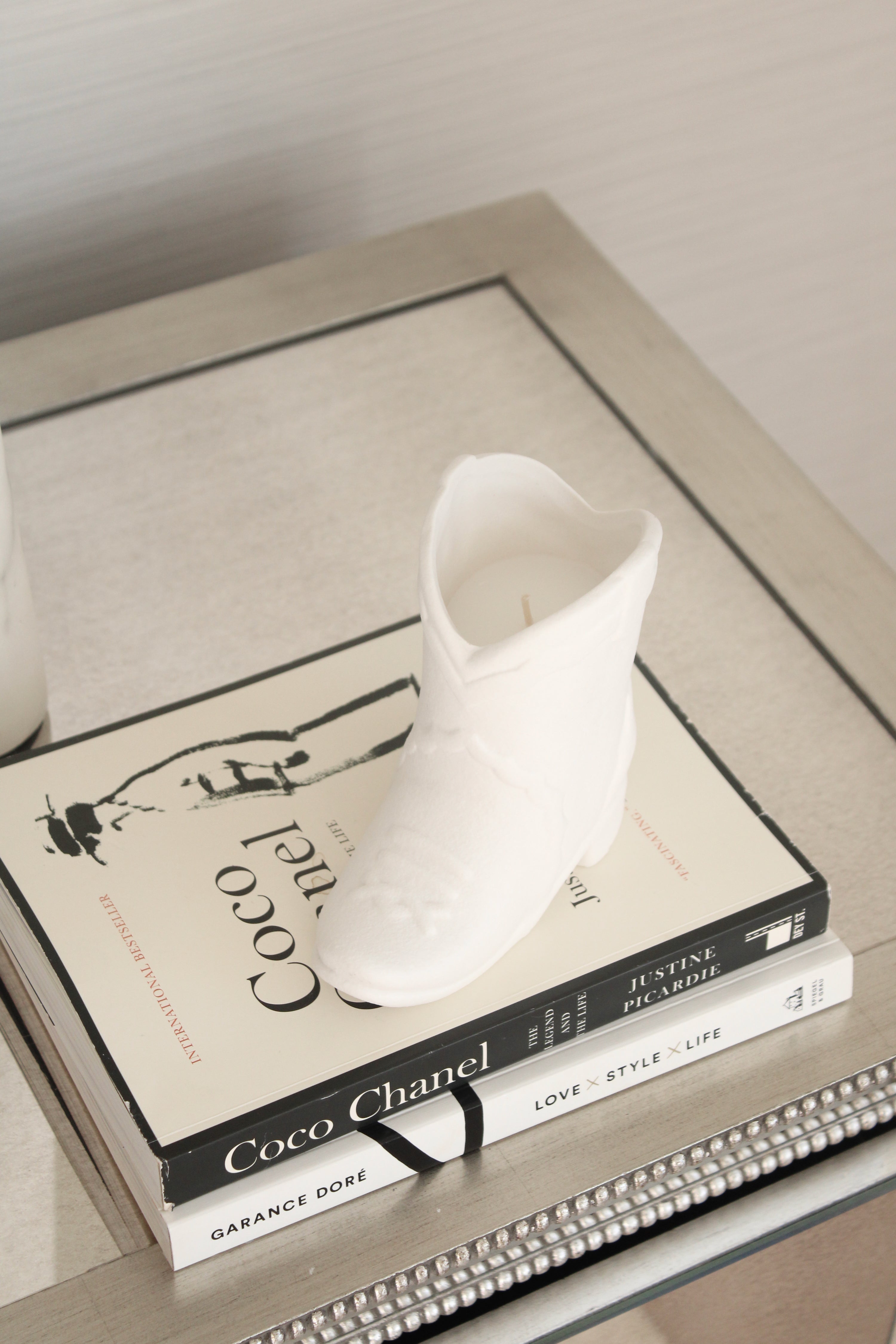 White ceramic cowboy boot candle with a warm smoked pistachio fragrance, blending vanilla, amber, and toasted spices. This chic western-inspired candle adds cozy cowgirl charm to equestrian home décor and can be reused as a decorative boot vase or keepsake after burning.
