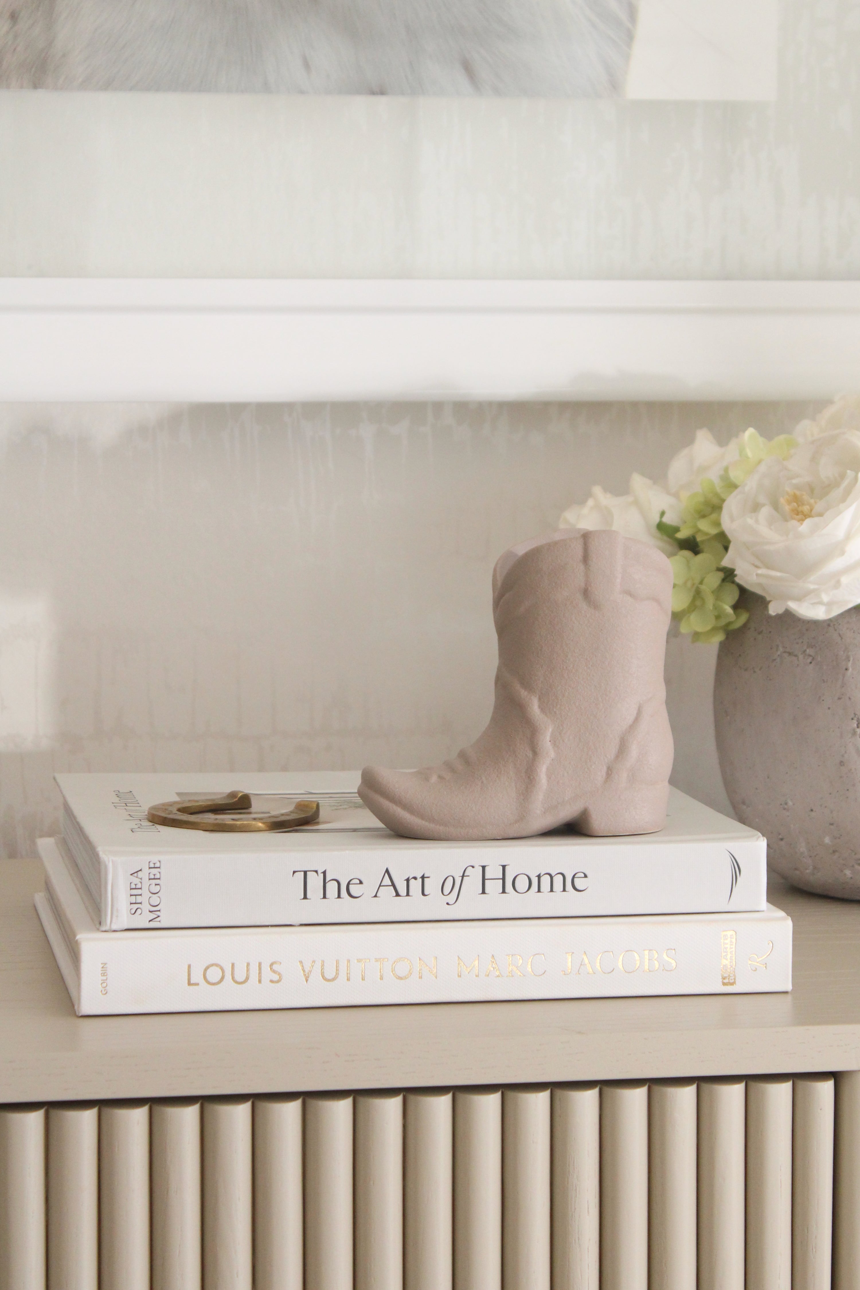 Matte tan ceramic cowboy boot candle with a cozy ranch-inspired scent of bergamot, mahogany, and amber. This western-style candle doubles as a keepsake container for pens or flowers, perfect for equestrian home décor and horse lover gifts.