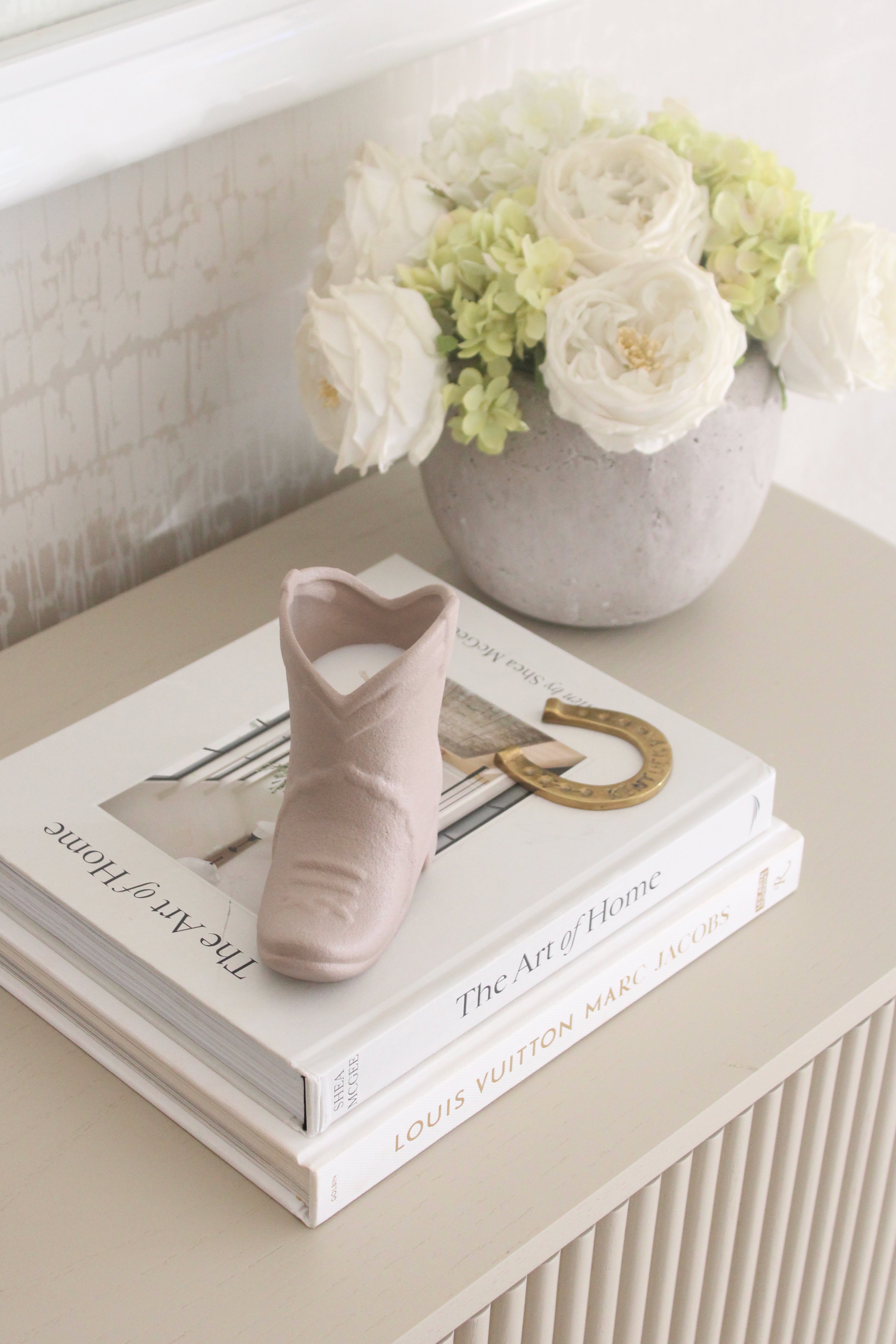 Matte tan ceramic cowboy boot candle with a cozy ranch-inspired scent of bergamot, mahogany, and amber. This western-style candle doubles as a keepsake container for pens or flowers, perfect for equestrian home décor and horse lover gifts.