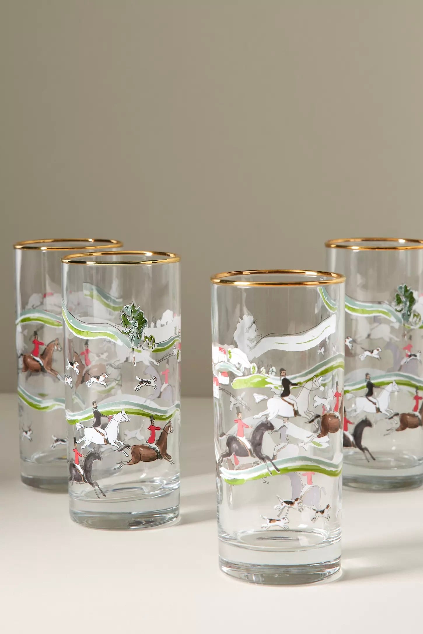 pomegranate inc stylish equestrian the hunt scene tall drinking glass set The Hunt Scene Drinking Glass Set featuring four tall glasses adorned with a detailed equestrian hunt scene and finished with elegant gold rims. A sophisticated horse-themed glassware set perfect for entertaining or gifting.