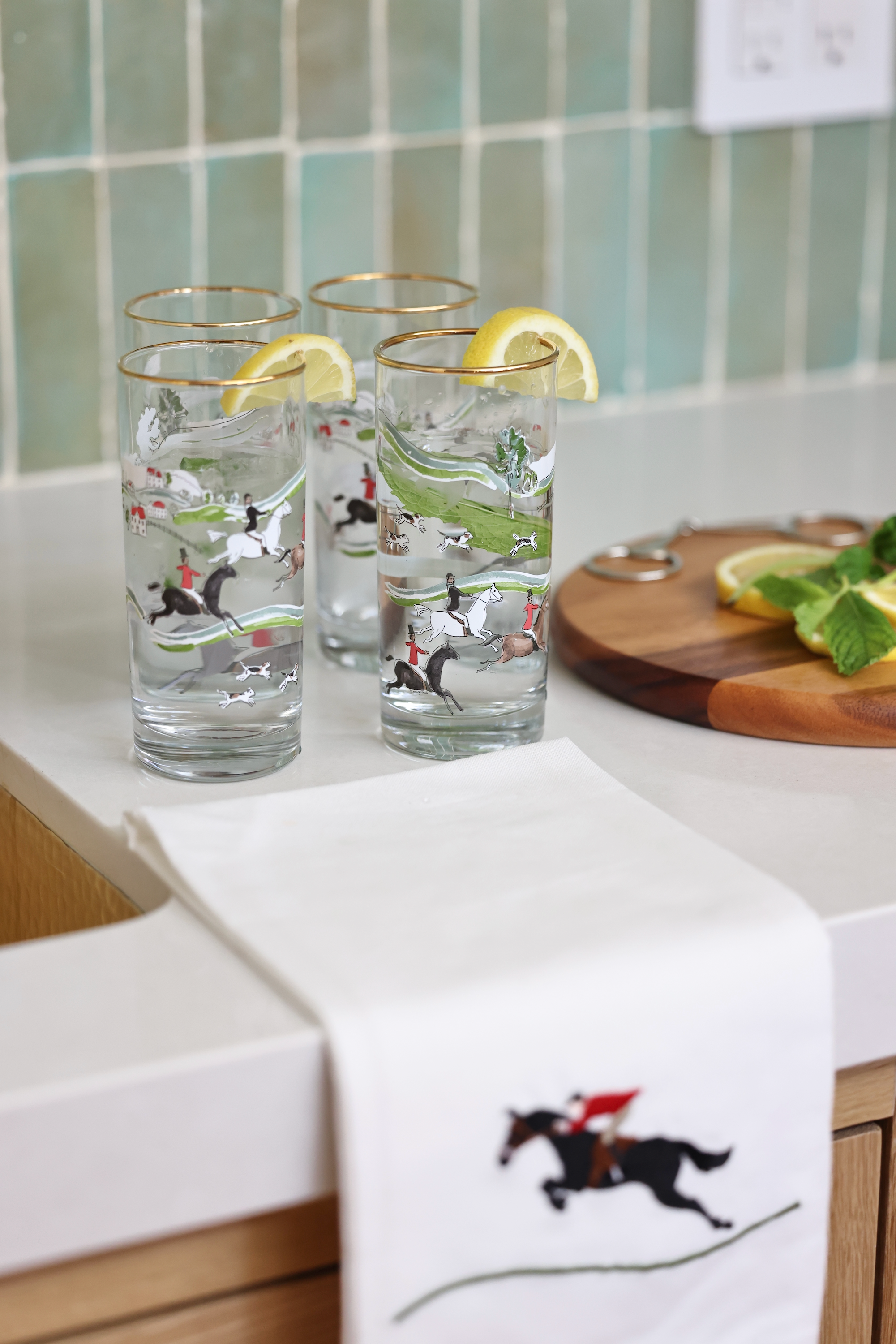 pomegranate inc stylish equestrian hunter drinking glass setThe Hunt Scene Drinking Glass Set featuring four tall glasses adorned with a detailed equestrian hunt scene and finished with elegant gold rims. A sophisticated horse-themed glassware set perfect for entertaining or gifting.