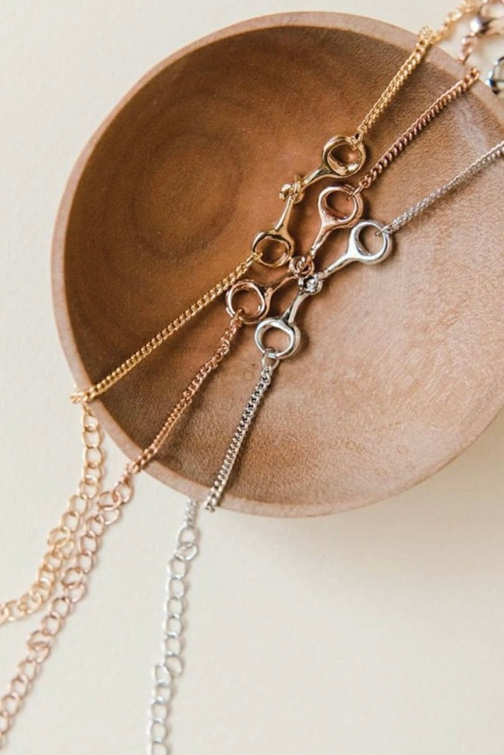 stylish equestrian dainty horse bit bracelet | Equestrian-inspired sterling silver bracelet featuring a delicate chain and center horse bit detail, adjustable for fit.