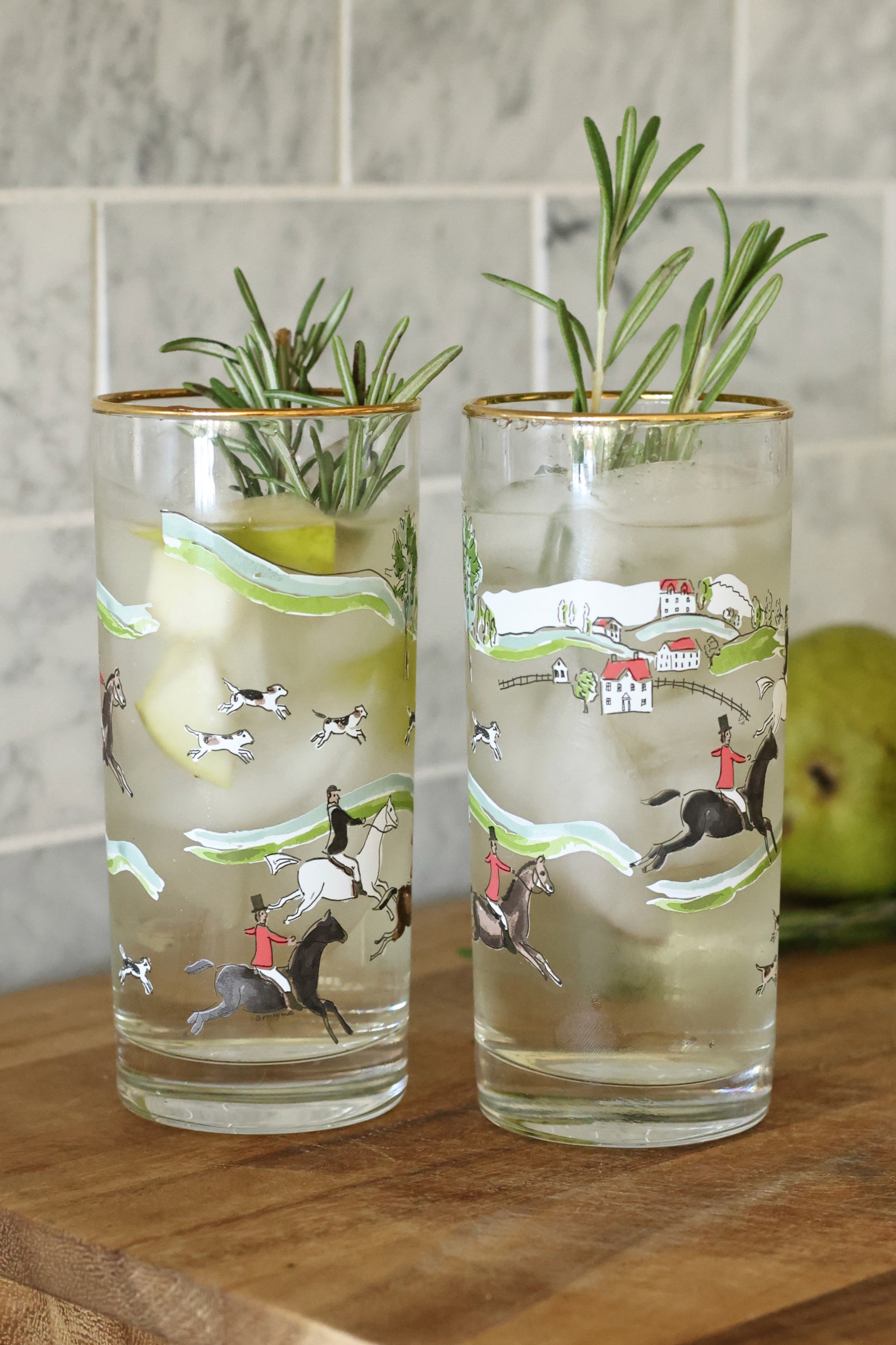 pomegranate inc stylish equestrian the hunt scene tall drinking glass set The Hunt Scene Drinking Glass Set featuring four tall glasses adorned with a detailed equestrian hunt scene and finished with elegant gold rims. A sophisticated horse-themed glassware set perfect for entertaining or gifting.