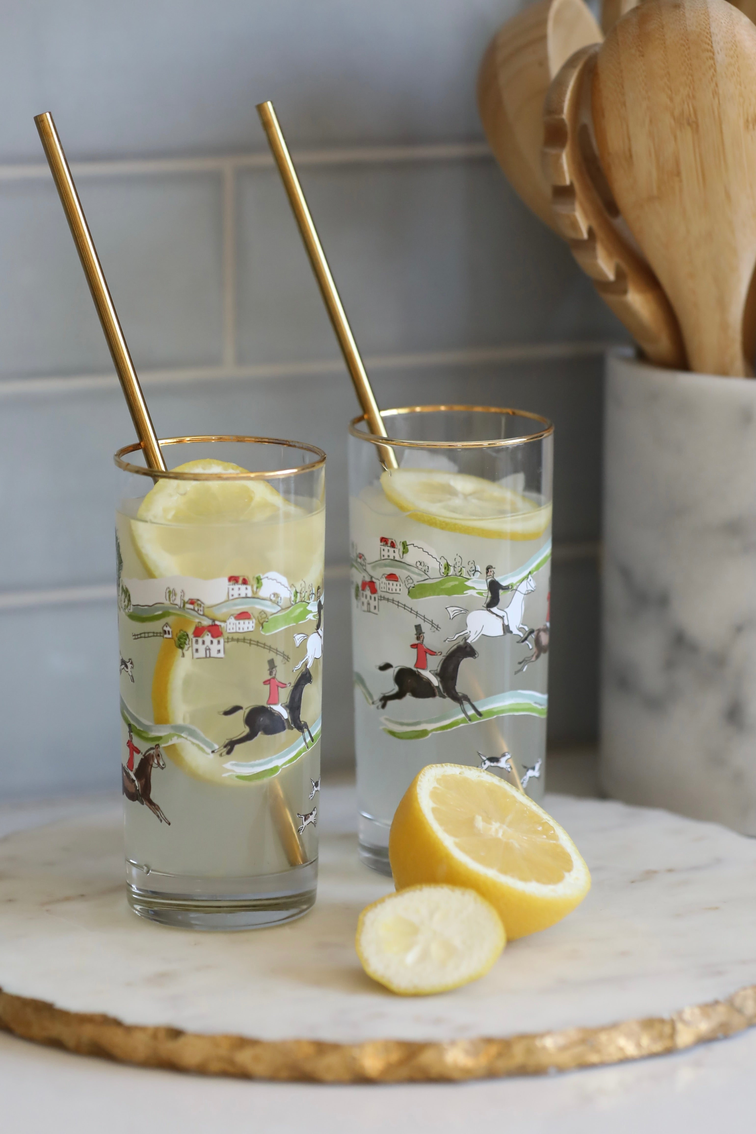 pomegranate inc stylish equestrian hunter drinking glass set The Hunt Scene Drinking Glass Set featuring four tall glasses adorned with a detailed equestrian hunt scene and finished with elegant gold rims. A sophisticated horse-themed glassware set perfect for entertaining or gifting.