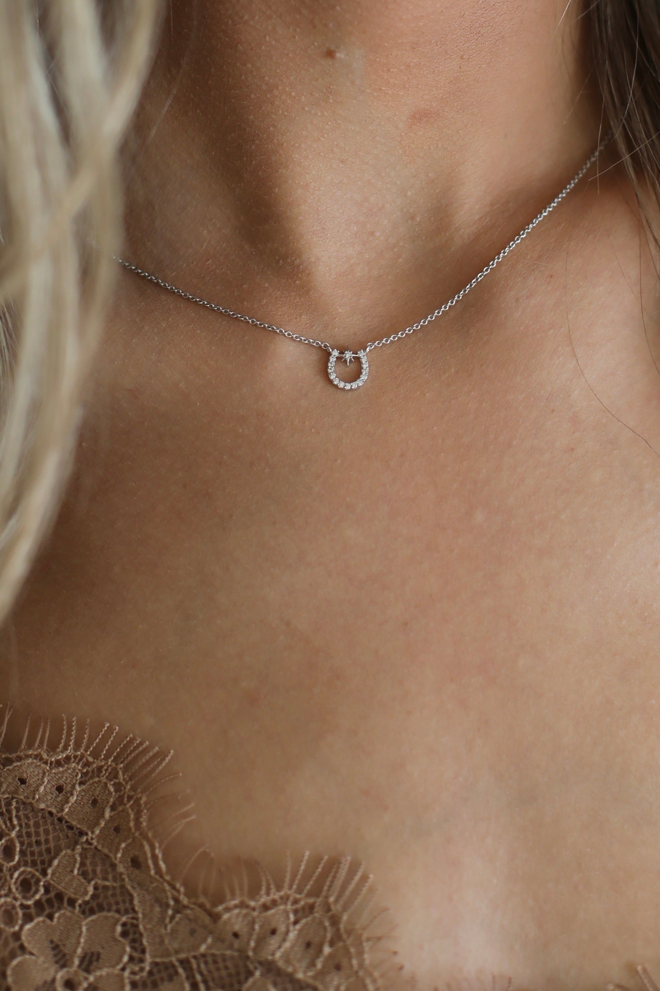 tai jewelry stylish equestrian lucky starlight horseshoe necklace | Dainty sterling silver horseshoe necklace with CZ starburst detail on an adjustable chain.