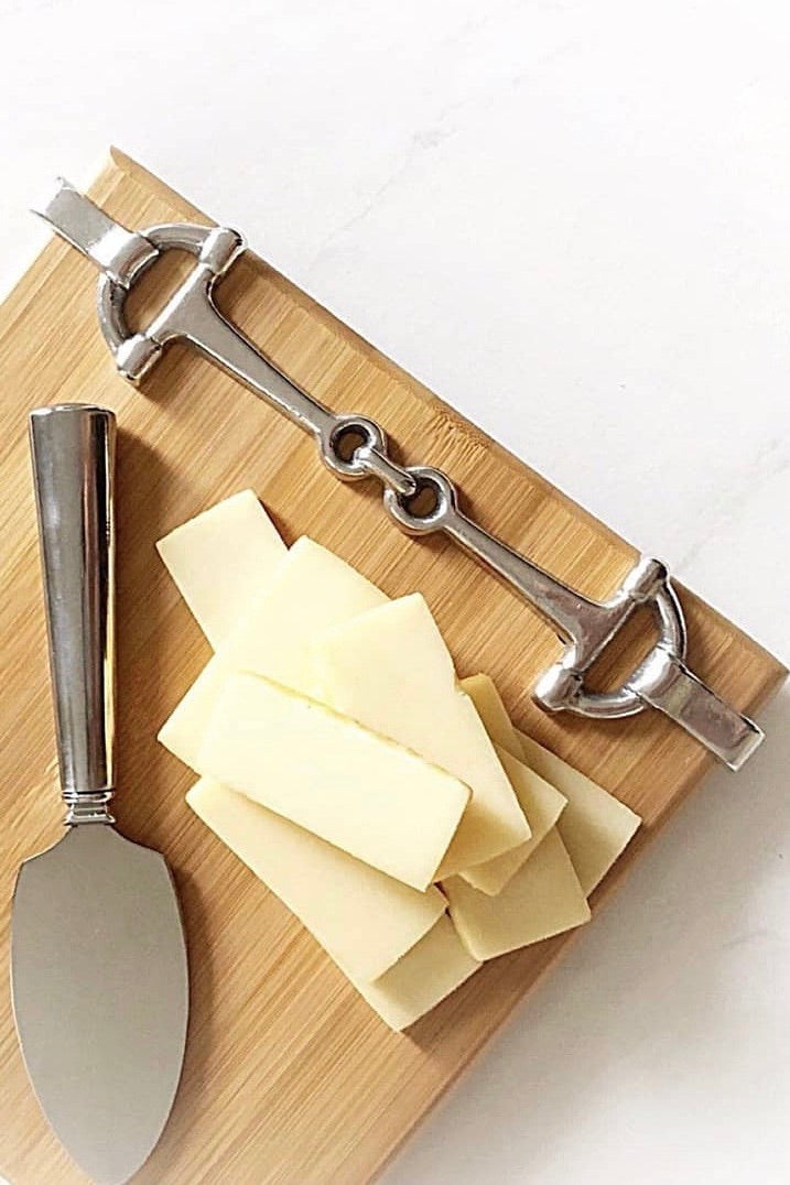 arthur court stylish equestrian well served cheese board snaffle set Well Served Set by Arthur Court featuring a bamboo serving board with a silver alloy horse bit accent, paired with a matching aluminum cheese knife and cracker tray. Elegant equestrian-themed serveware perfect for entertaining or gifting.