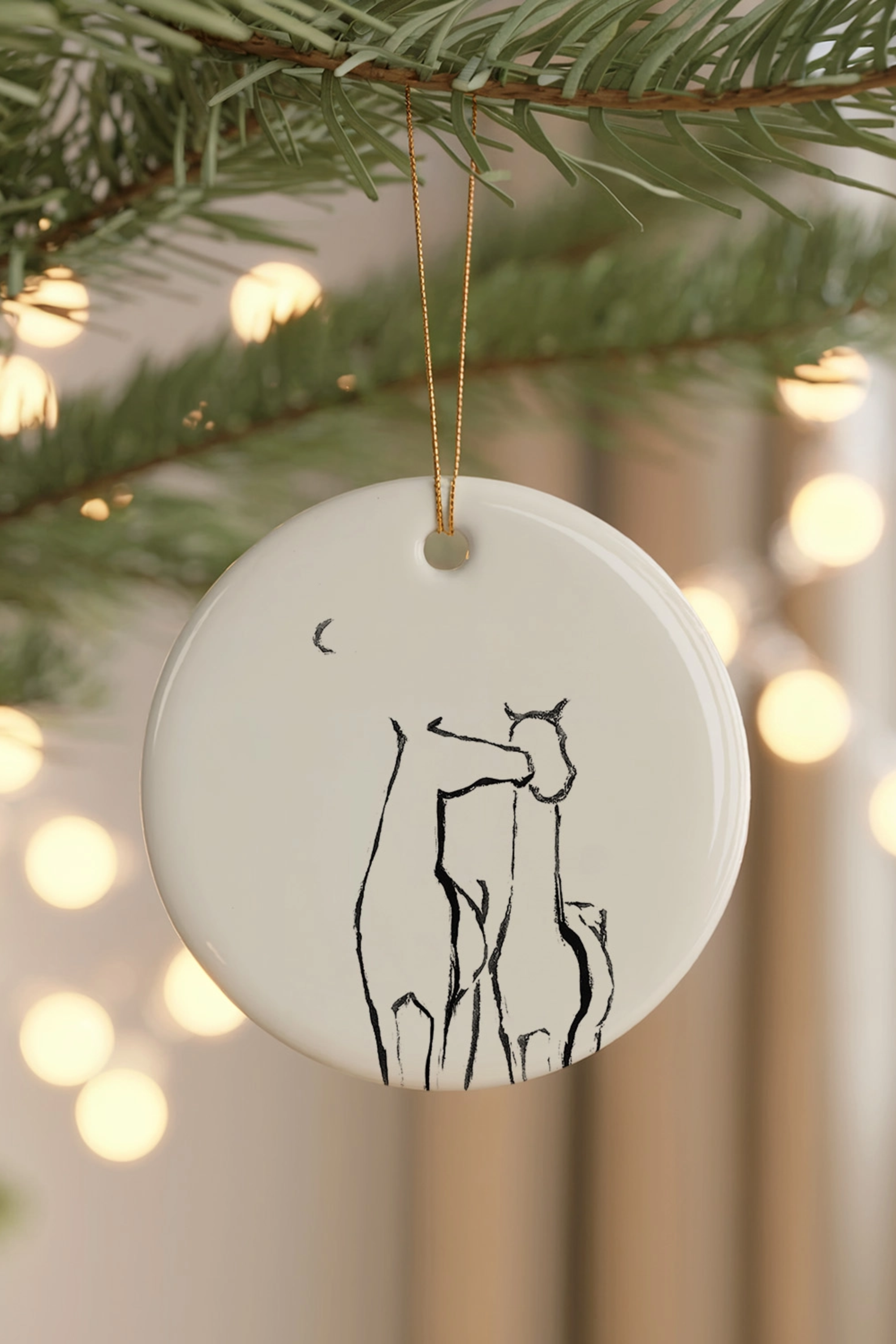 Besos Ornament — ceramic equestrian-inspired Christmas ornament featuring original horse artwork by Bettina, accented with gold tinsel. A charming horse-themed holiday decoration and thoughtful Christmas gift for equestrians and horse lovers. Made in the USA.