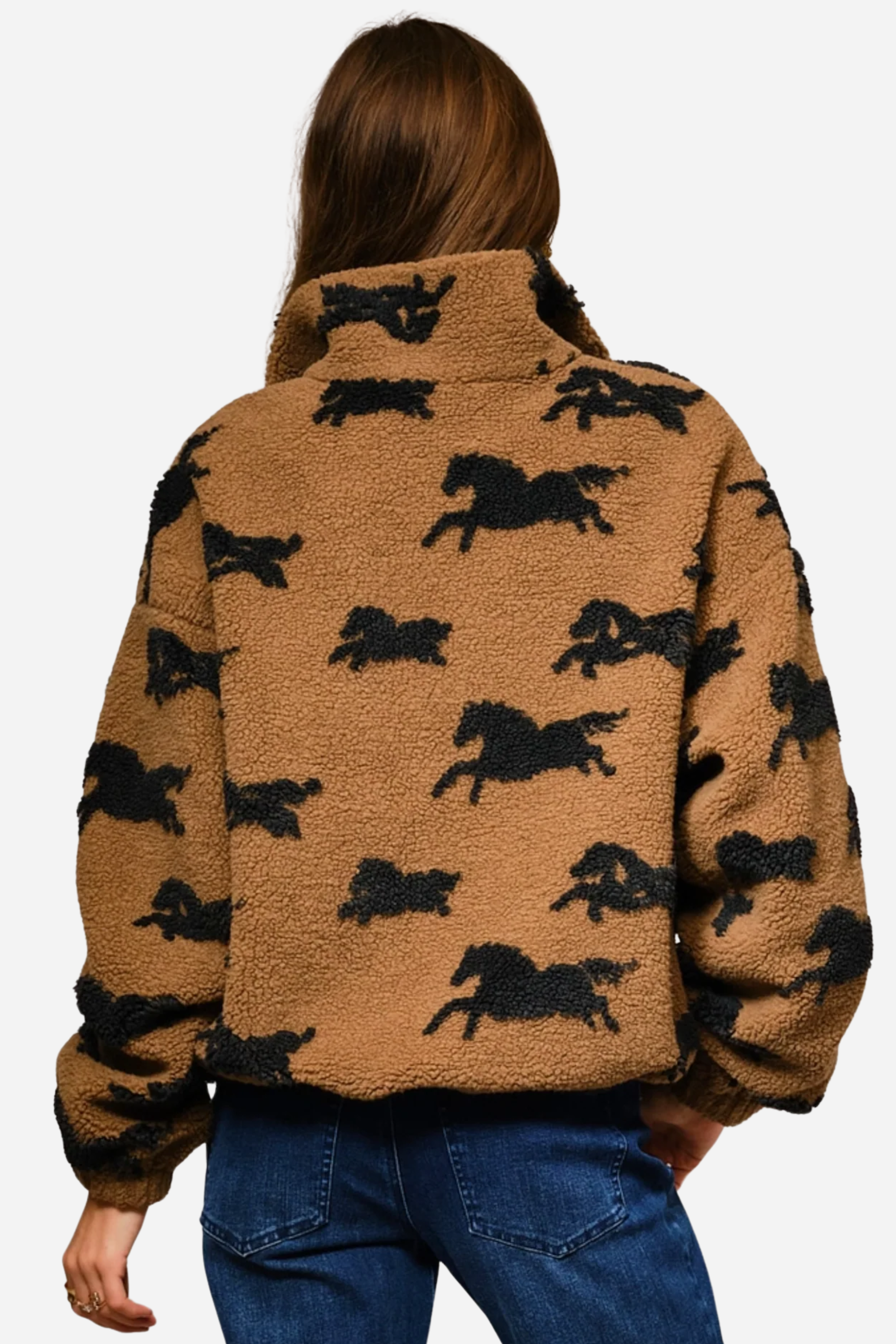 Woman wearing a brown fleece jacket with black horse patterns on a plain background - equestrian sherpa jacket, equestrian jacket, horse print jacket, equestrian outerwear