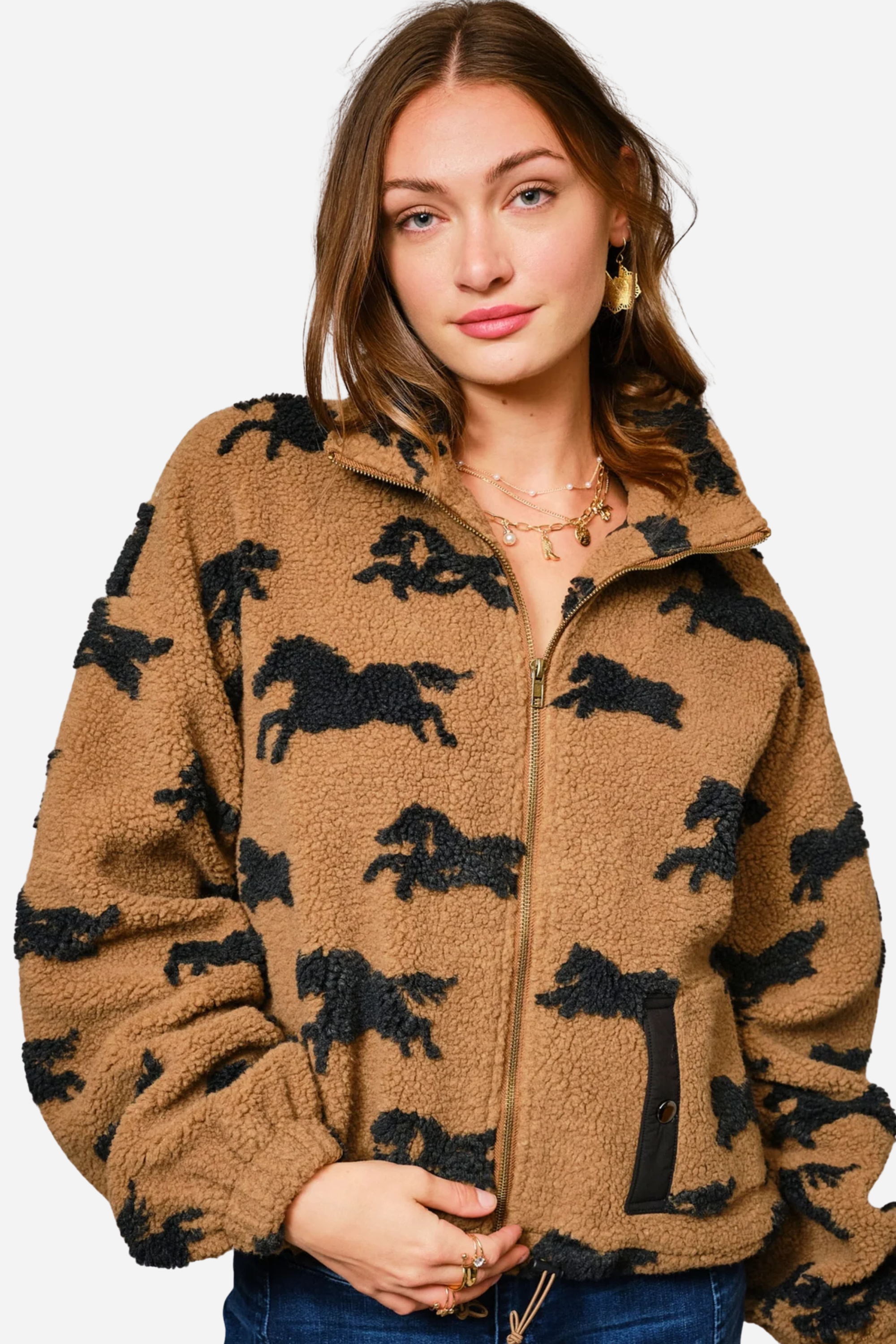 Woman wearing a brown fleece jacket with black horse patterns on a plain background - equestrian sherpa jacket, equestrian jacket, horse print jacket, equestrian outerwear